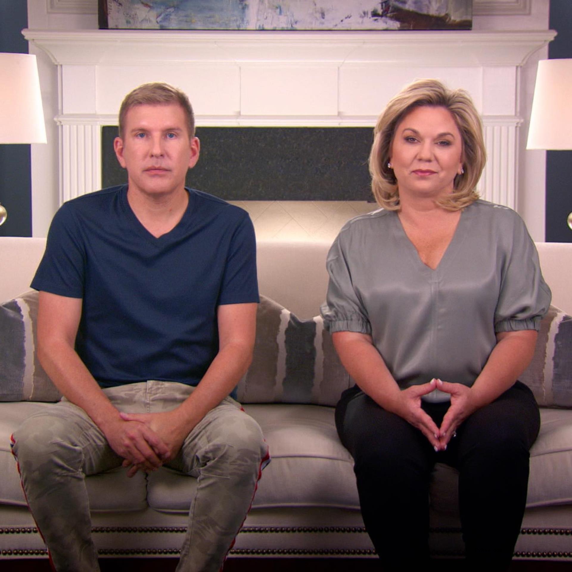 Julie Chrisley and Todd Chrisley sitting on a couch.