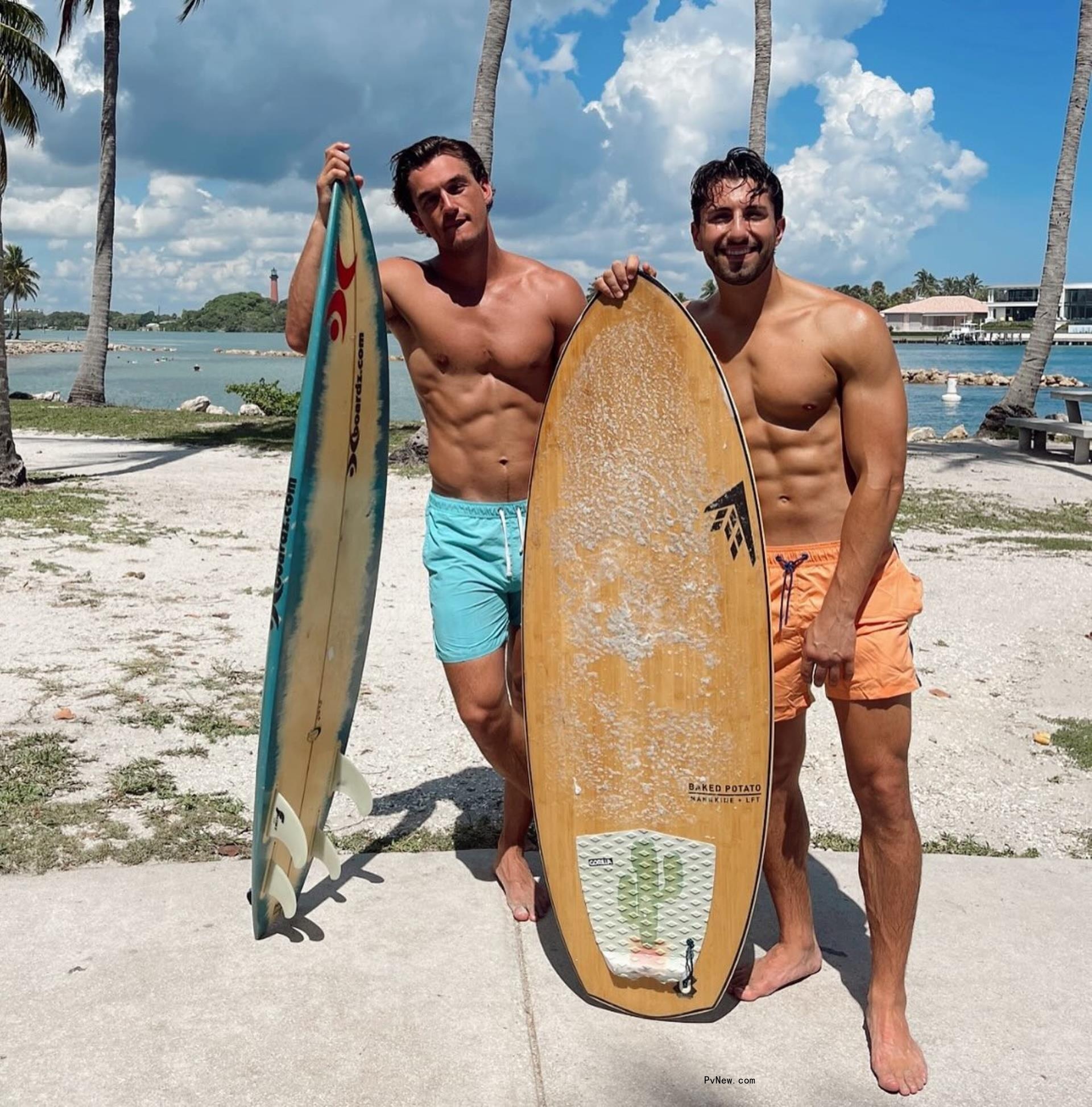 Jason Tartick and Tyler Cameron shirtless at a beach.