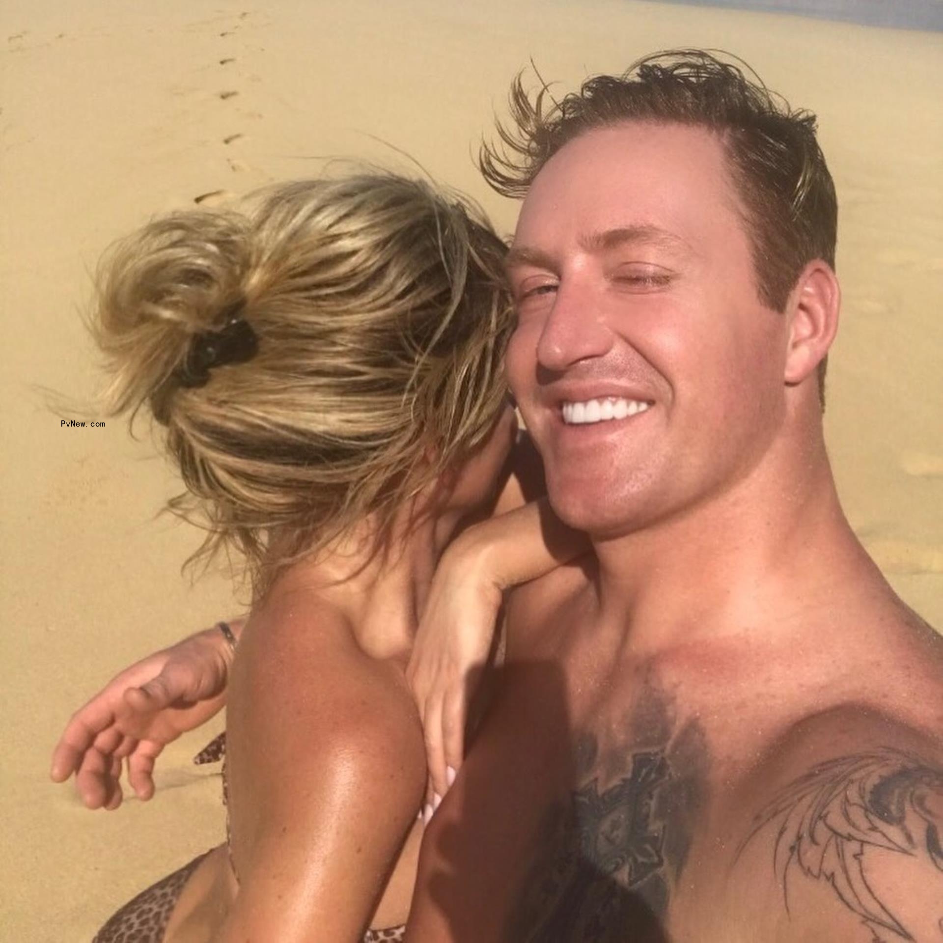 kim zolciak in a bikini and kroy biermann shirtless hugging on the beach