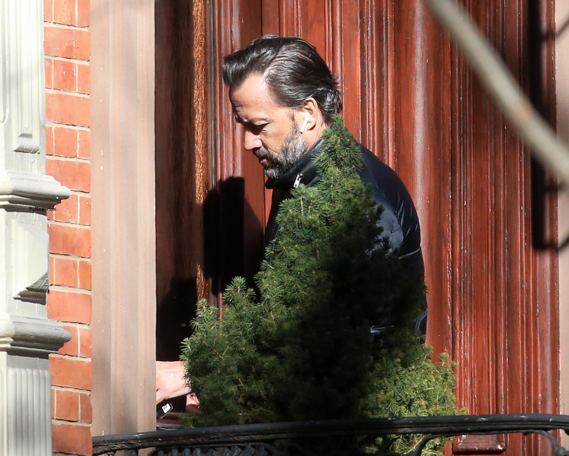 Andrew Shue walking into his apartment