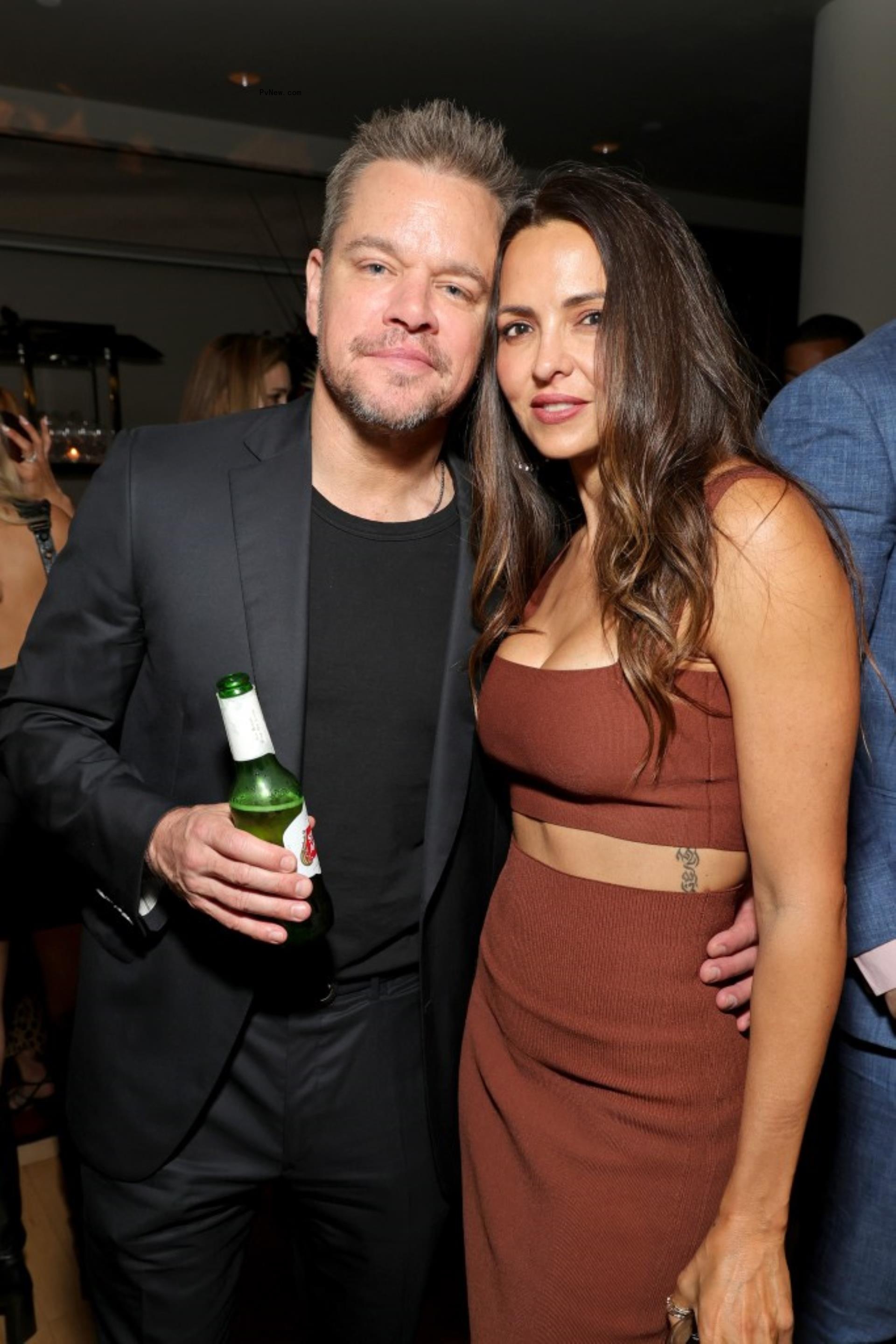 Matt Damon and Luciana Barroso posing at an event.