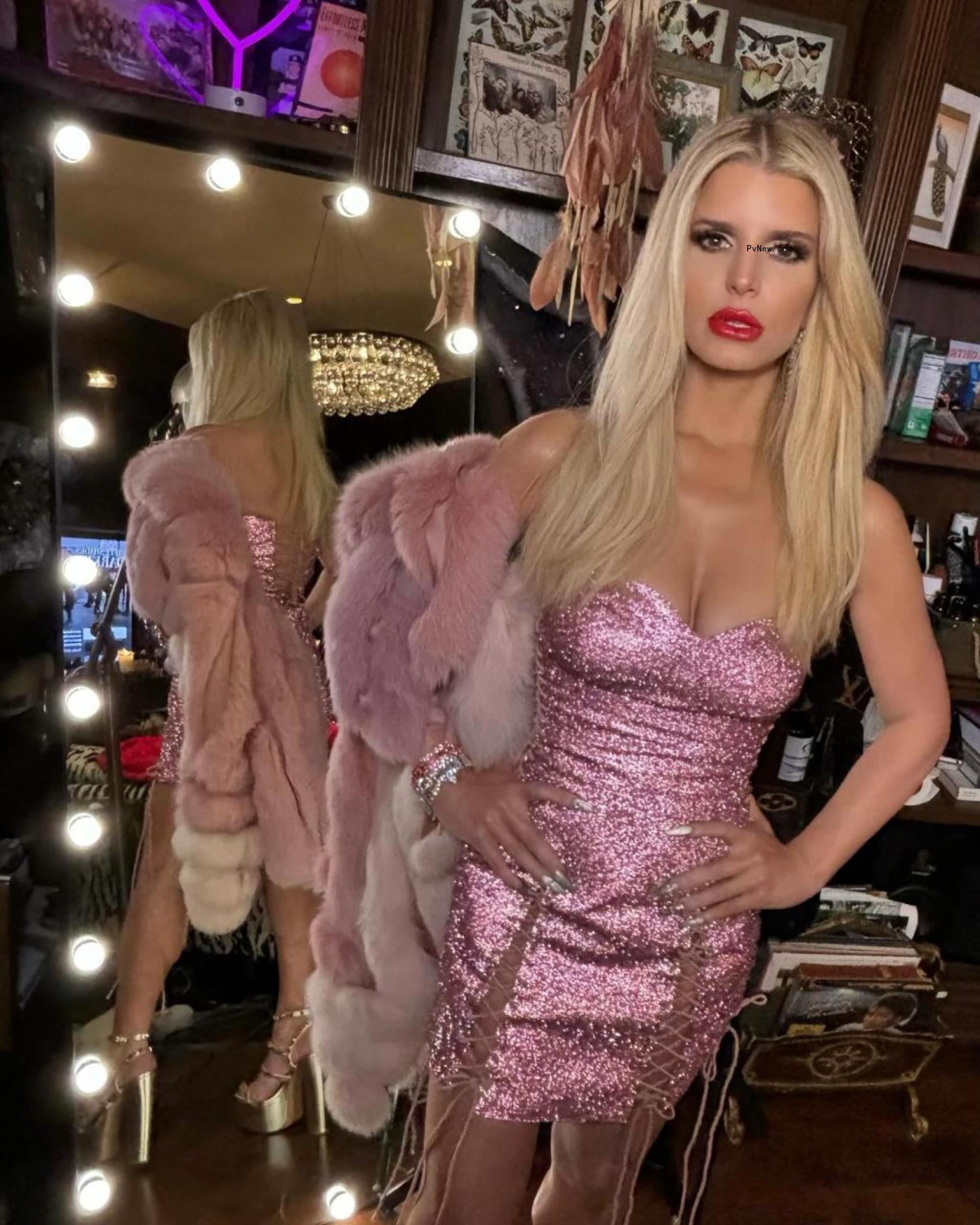 Jessica Simpson posing in a strapless dress