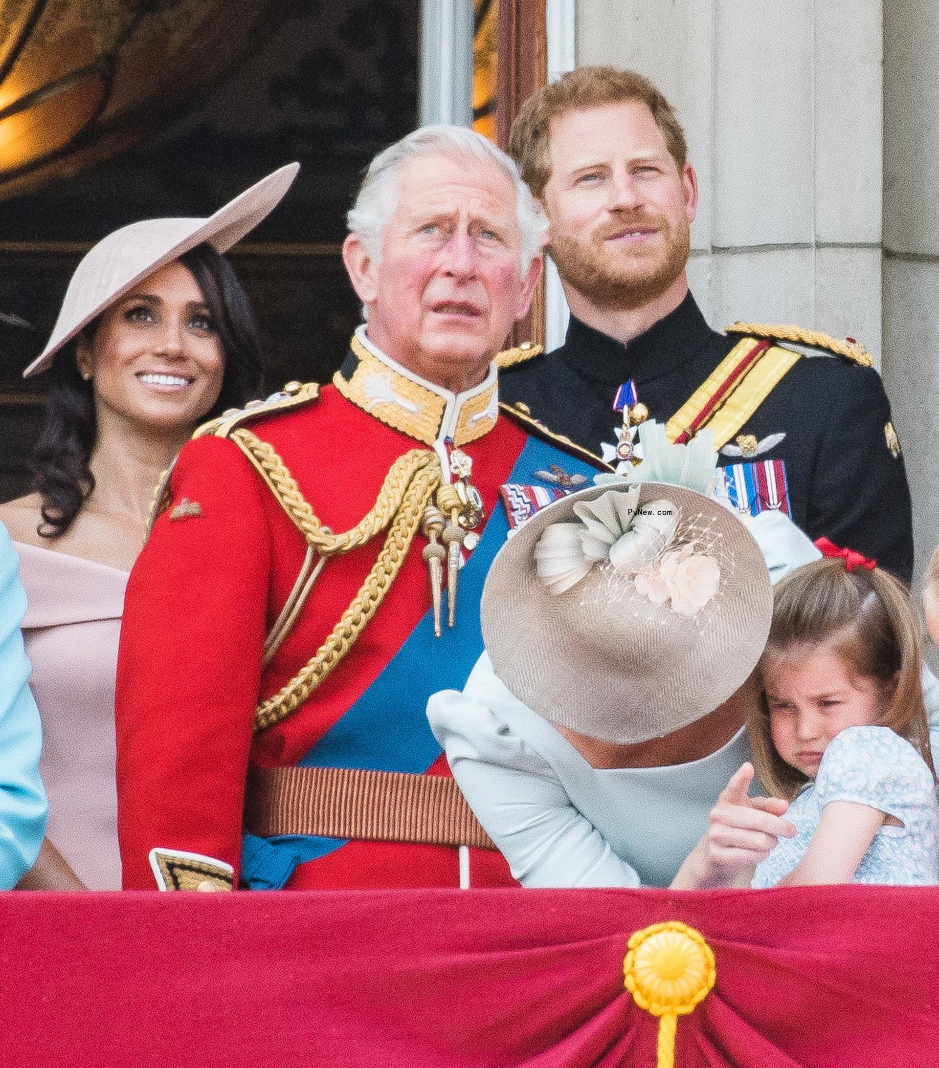 Meghan Markle, King Charles and Prince Harry on Buckingham Palace balcony.