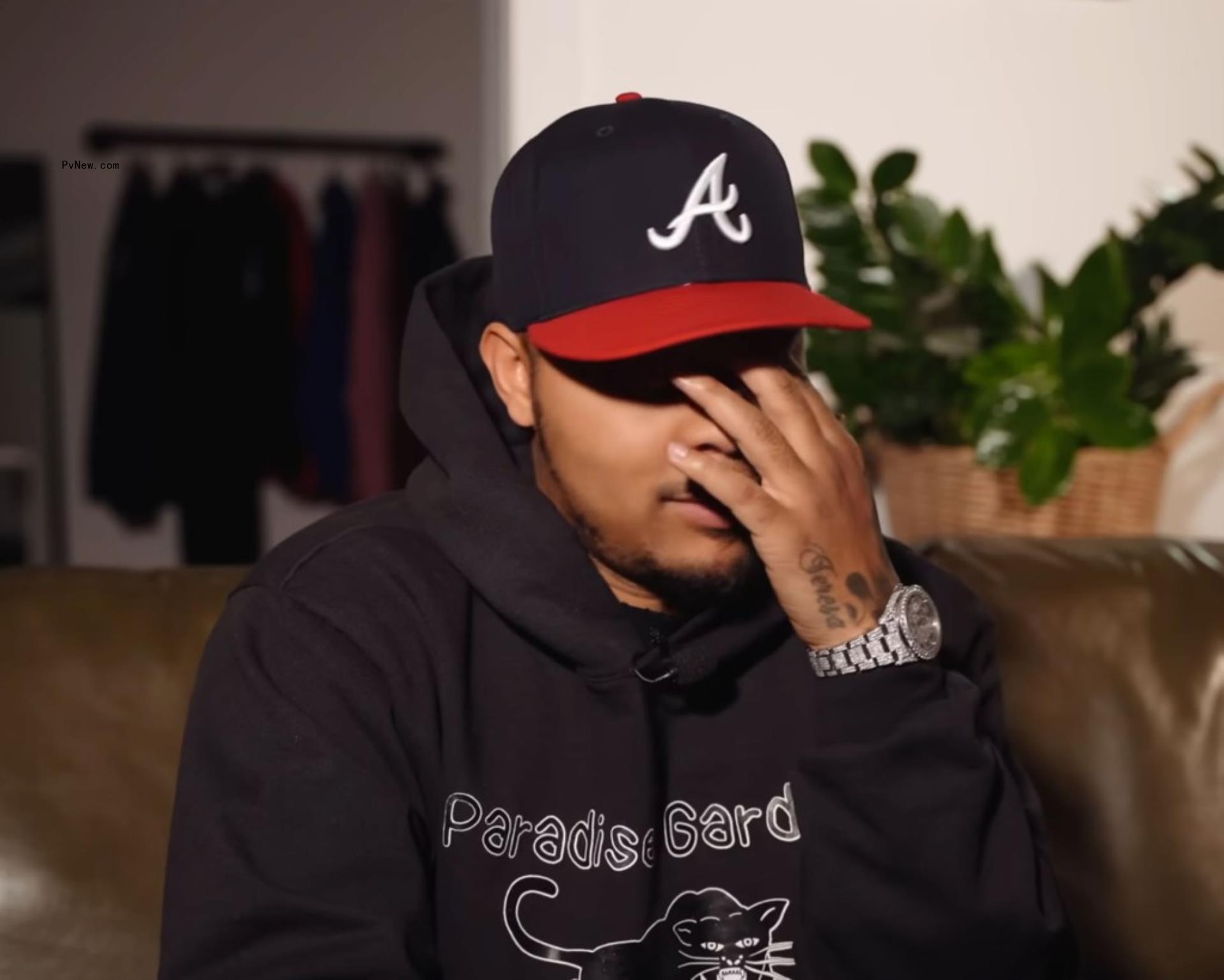rapper bow wow putting his face in his hand
