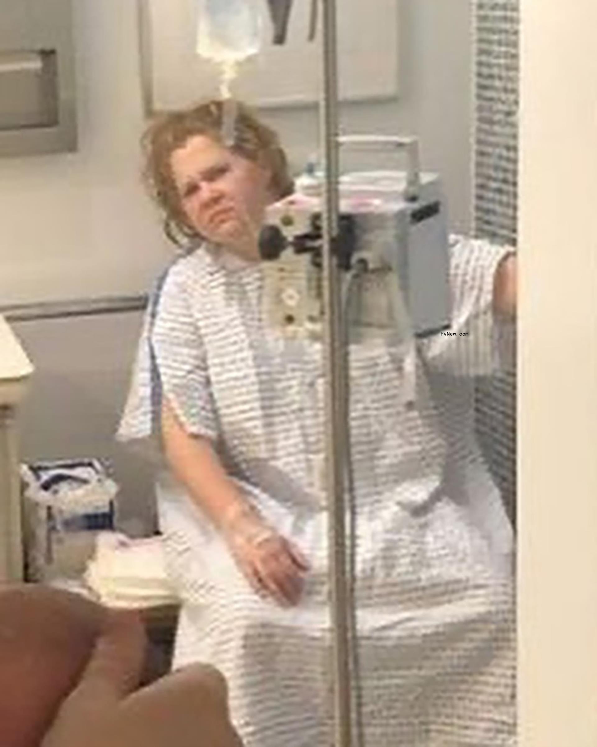 amy schumer dressed in a hospital gown and hooked up to an IV