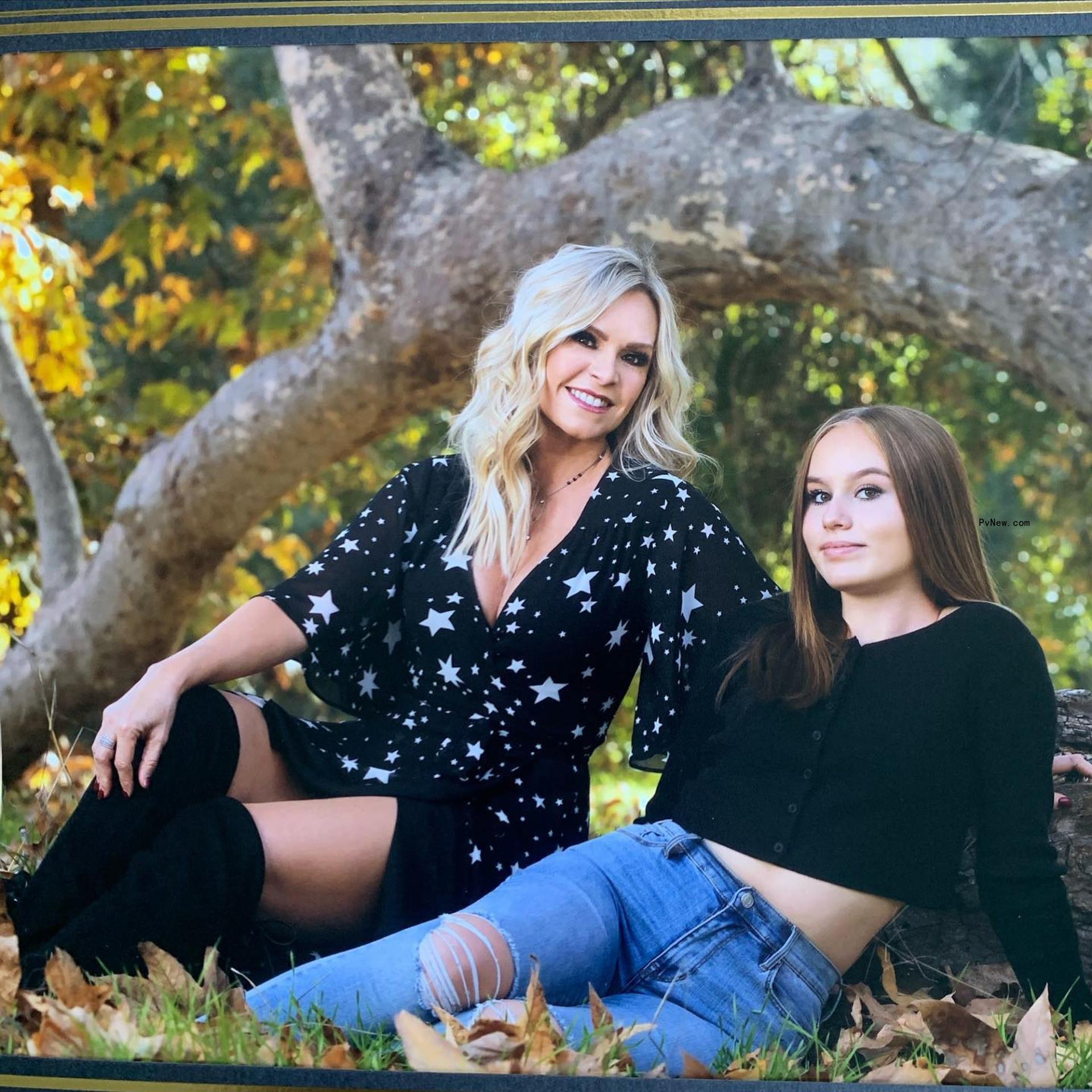 Tamra Judge posing in front of a tree with her daughter Sophia