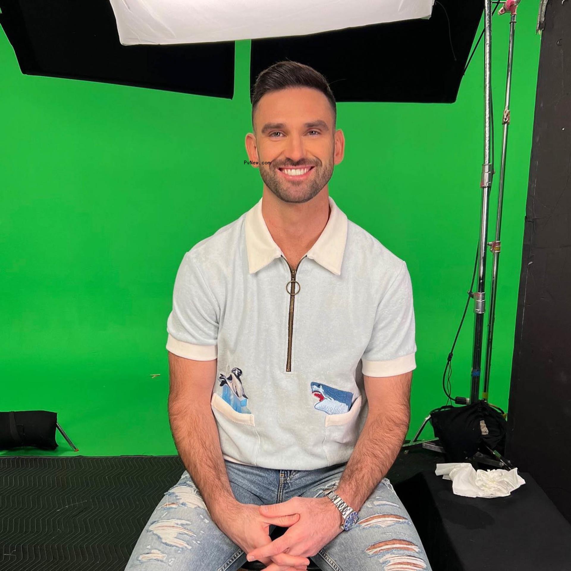 Carl Radke sitting in front of a green screen