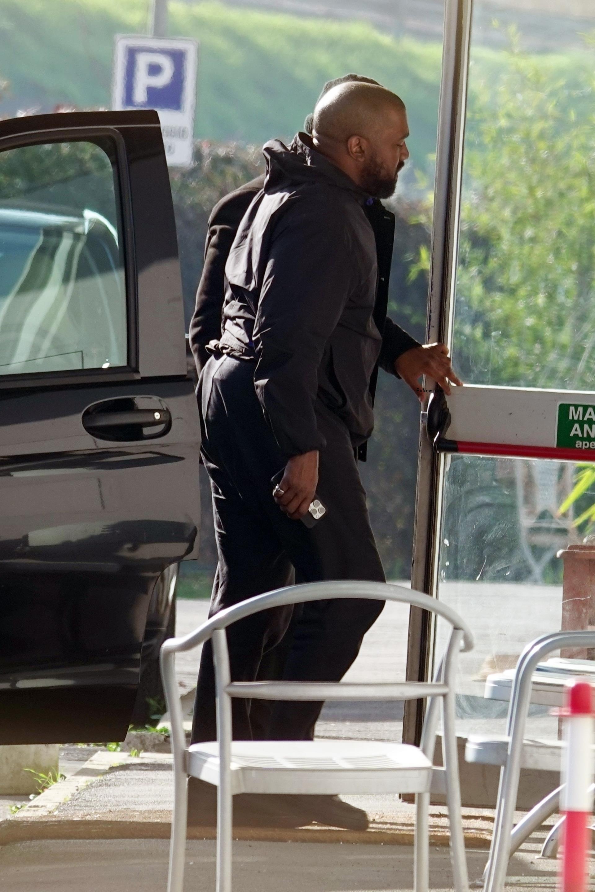 Kanye West walking out of a car