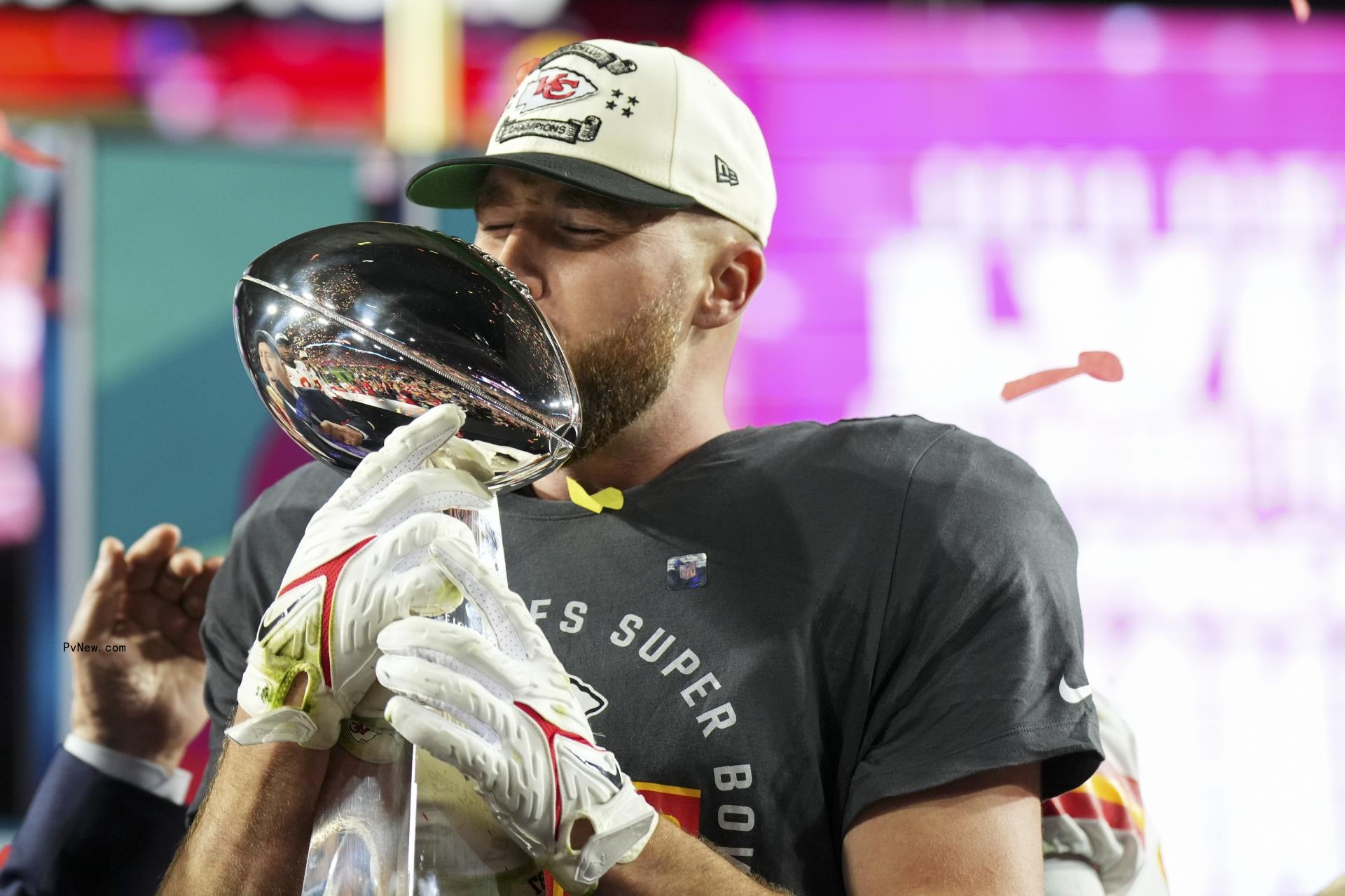 Travis Kelce kissing the Super Bowl trophy