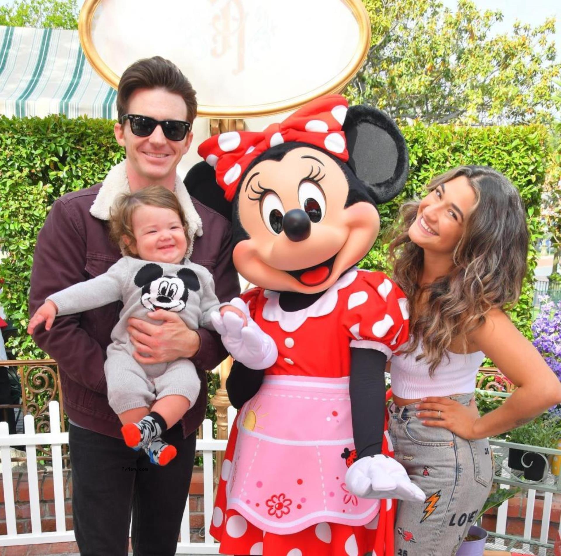 Drake Bell and Janet Von Schmeling with their son at Disney World.