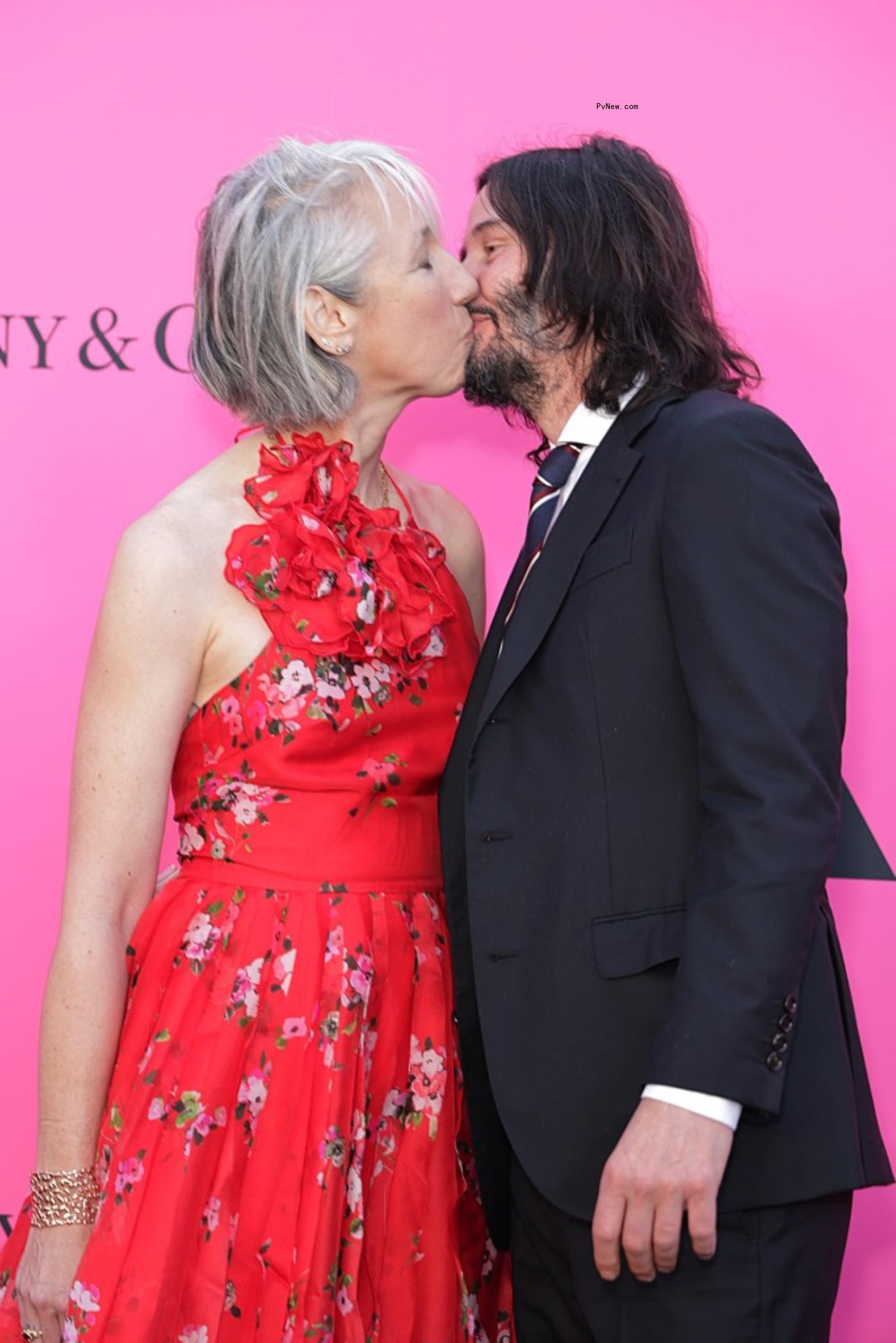 Keanu Reeves and Alexandra Grant kissing.