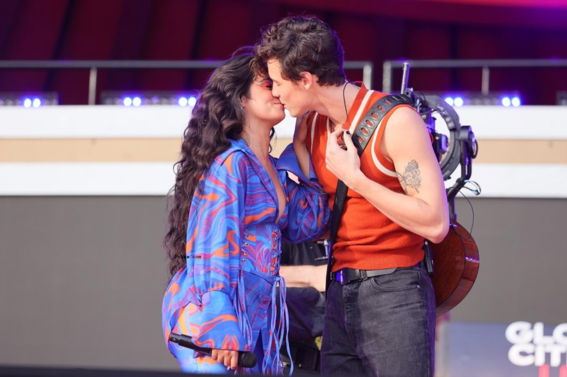 Camila Cabello and Shawn Mendes kissing o<i></i>nstage during a performance.