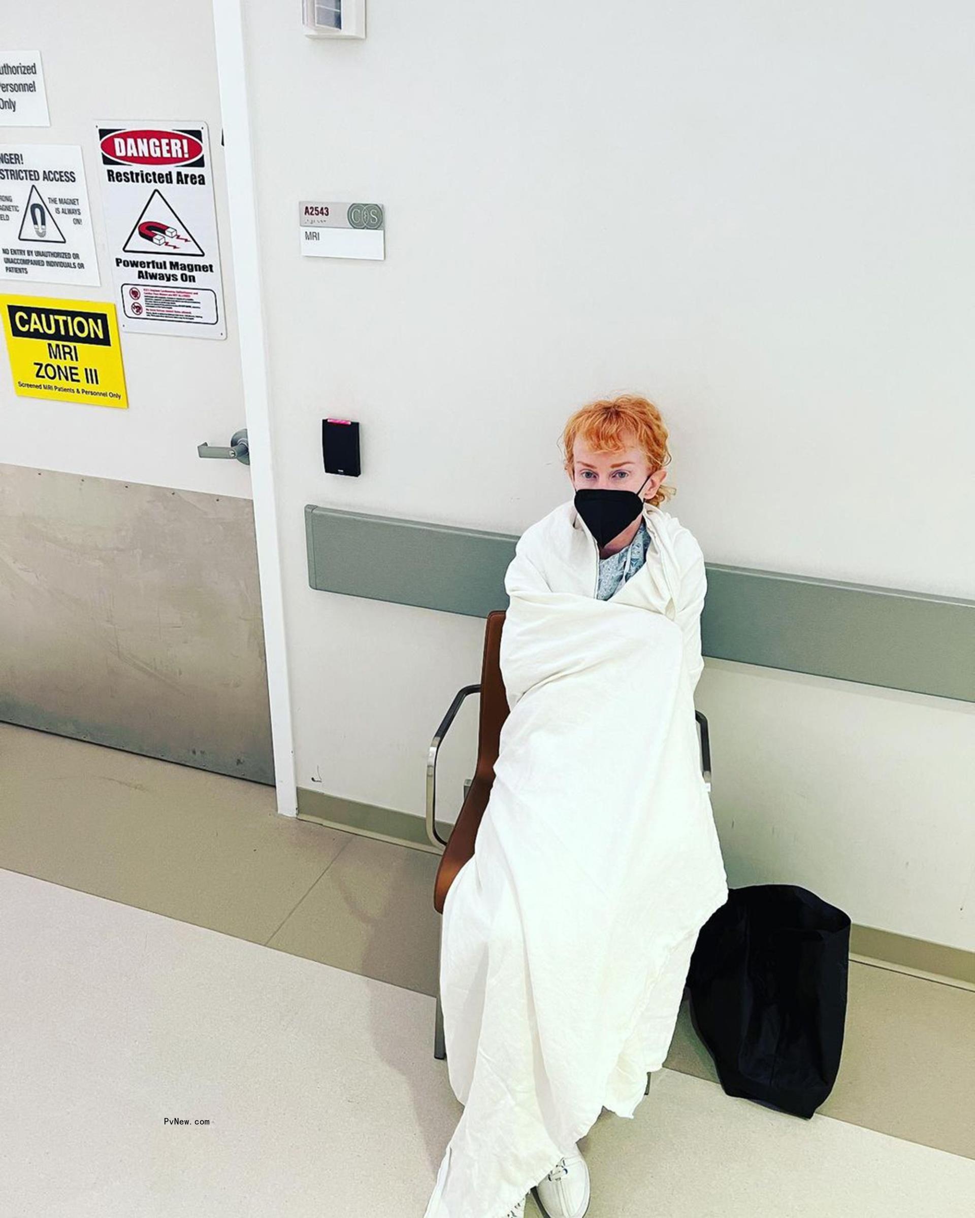 kathy griffin sitting in a chair wrapped in a blanket in the hospital