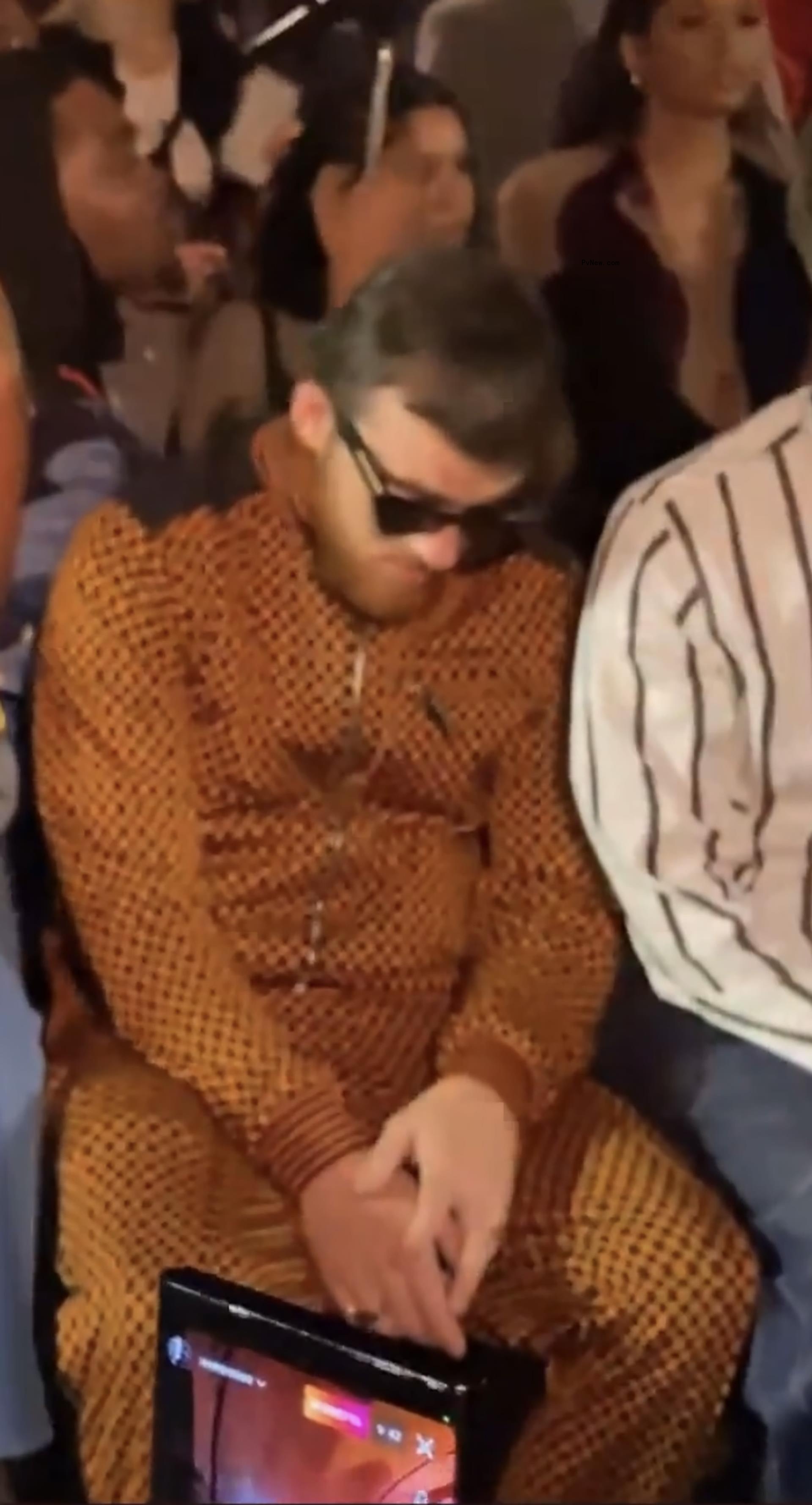 Angus Cloud seemingly asleep at a fashion show.