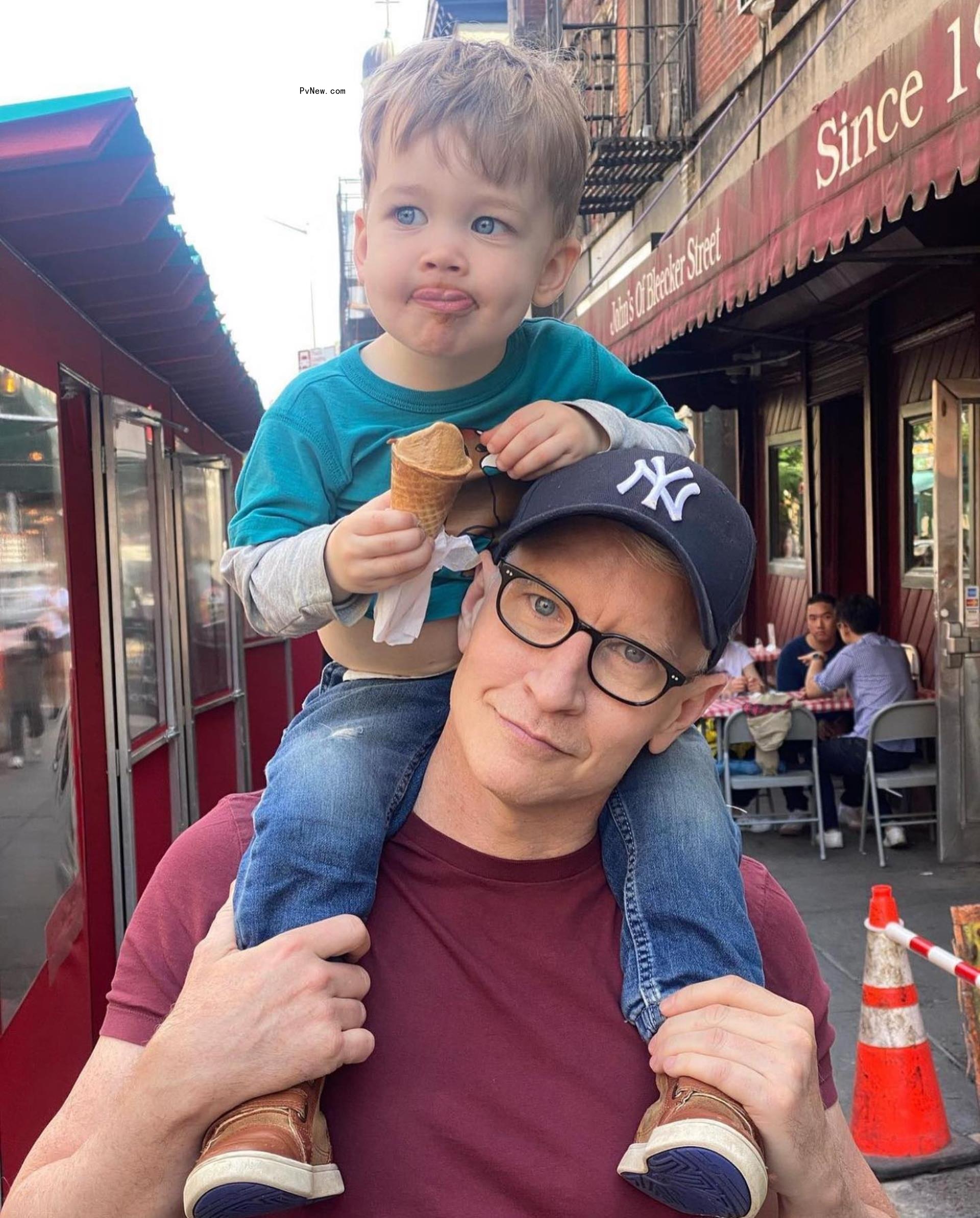 Anderson Cooper and his kid on his shoulders.
