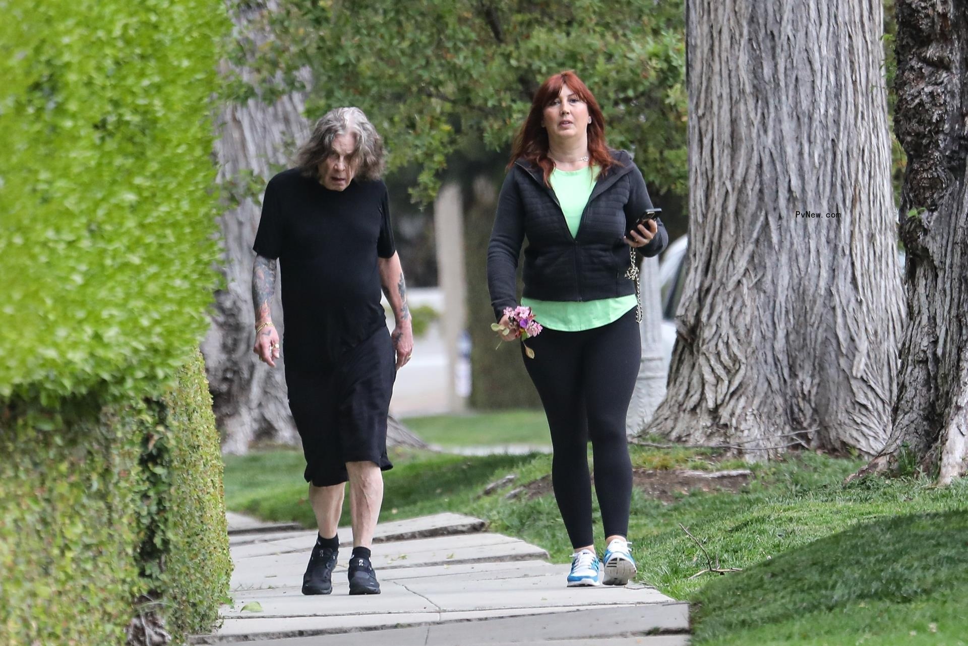 Ozzy Osbourne walks without cane in black outfit