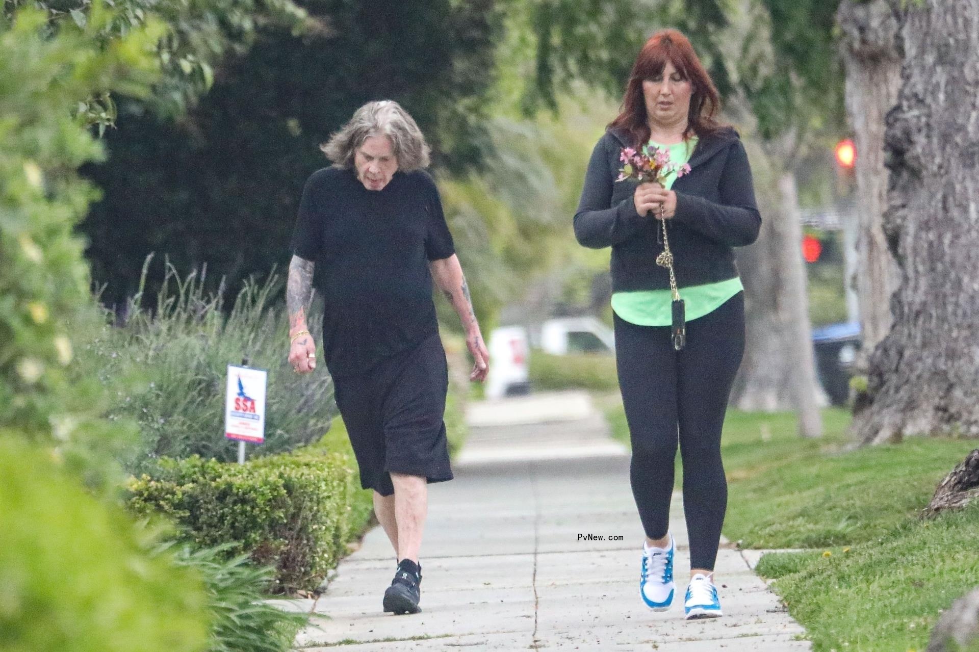 Ozzy Osbourne walks without cane in black outfit
