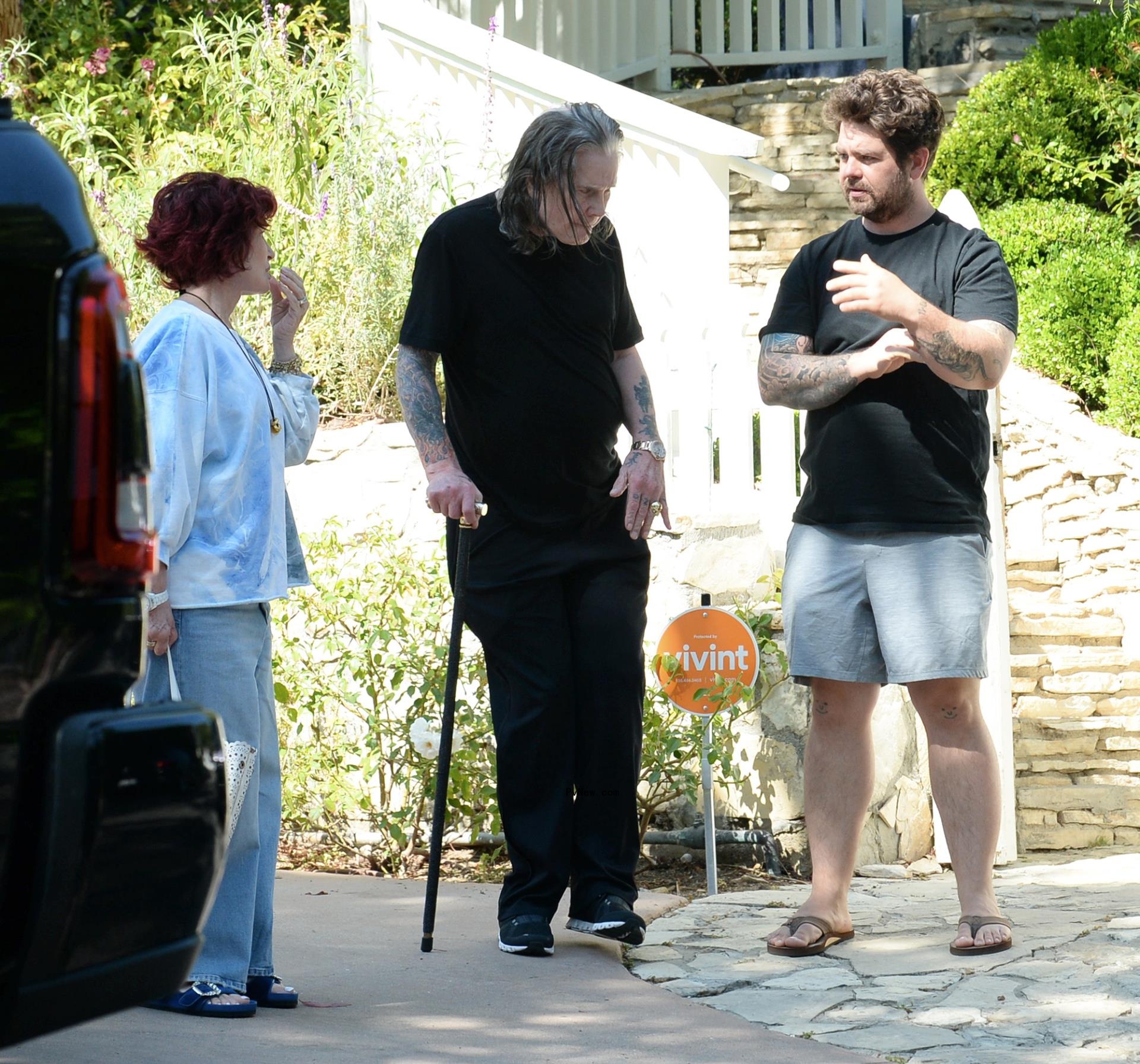 Ozzy Osbourne walks with cane