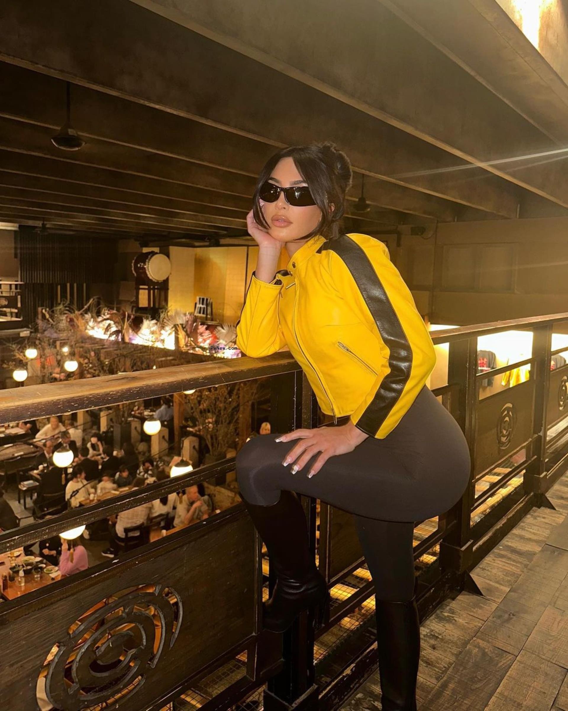 Kim Kardashian eats sushi in yellow moto jacket