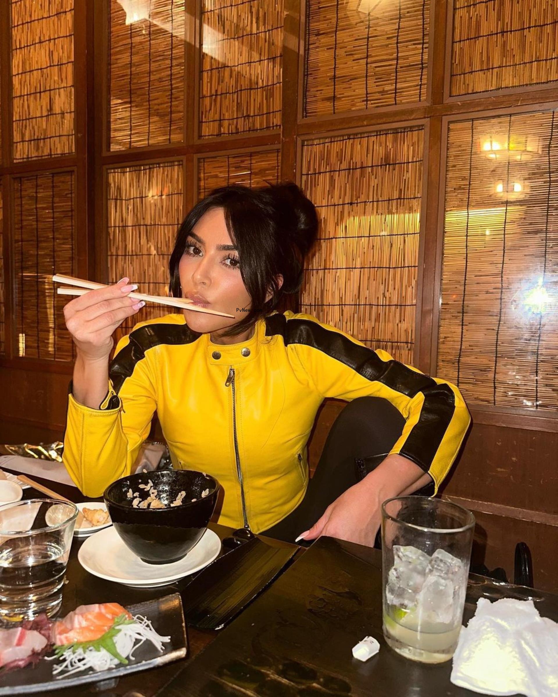Kim Kardashian eats sushi in yellow moto jacket