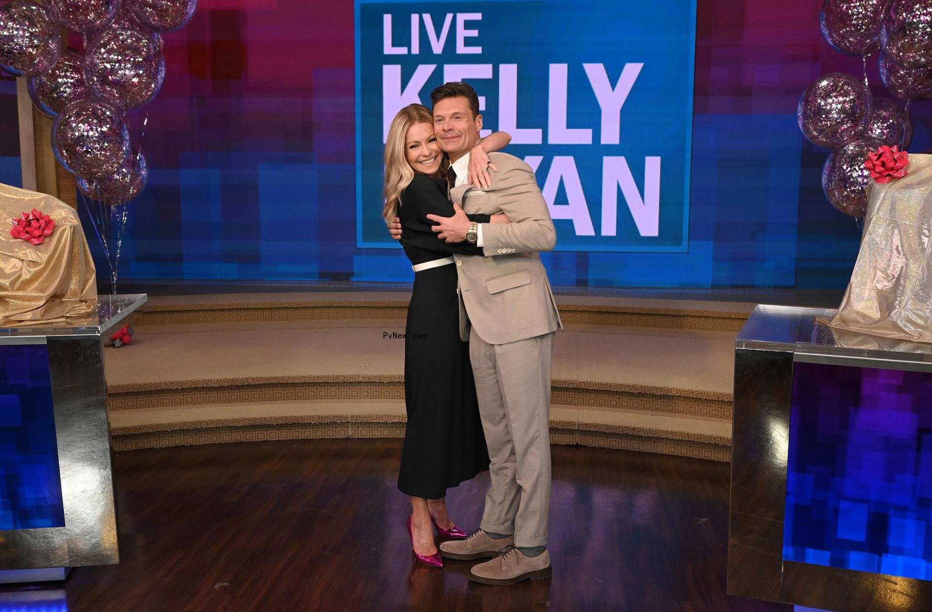 Kelly Ripa and Ryan Seacrest hugging on