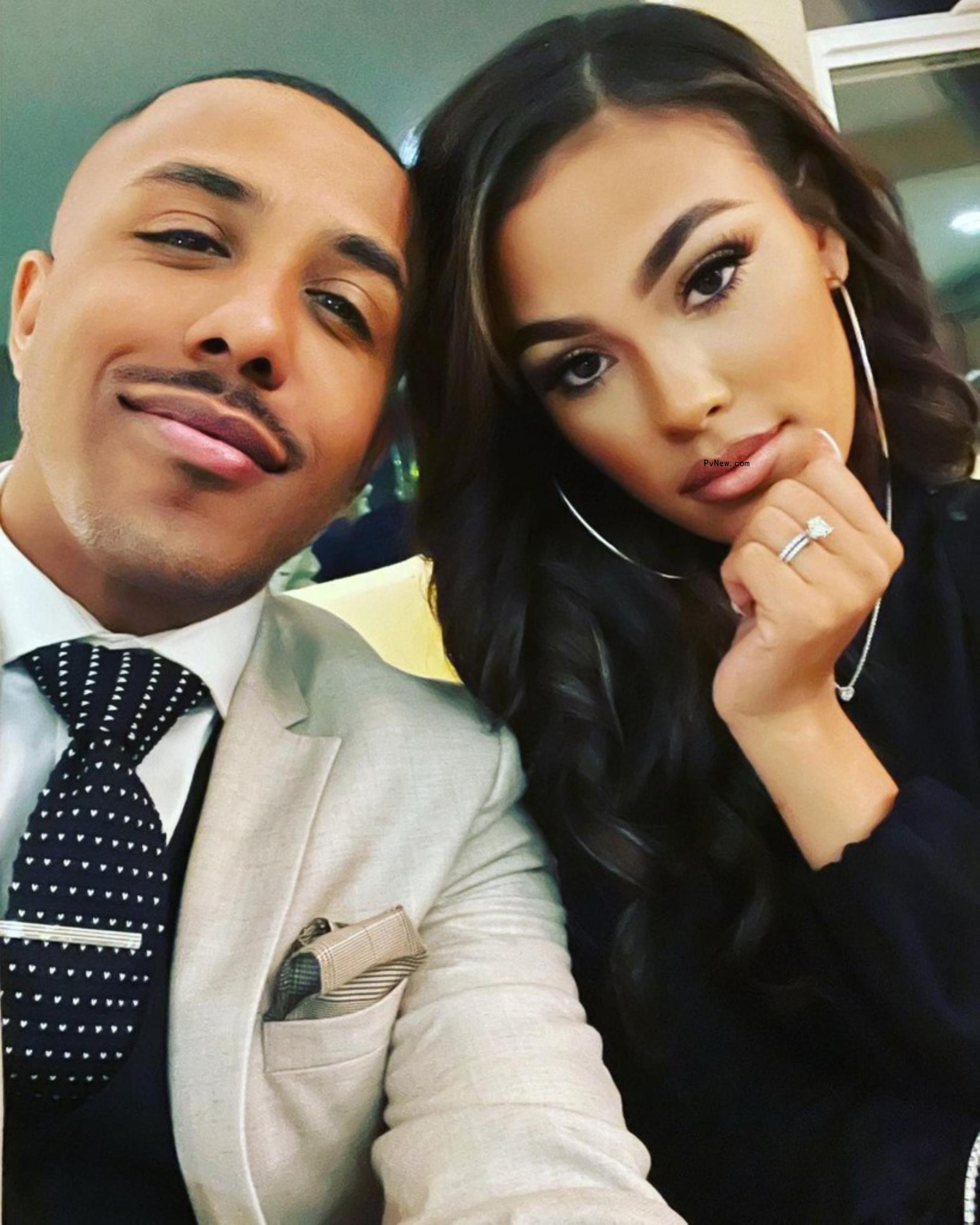 Marques Houston and his wife Miya posing in a close up photo.