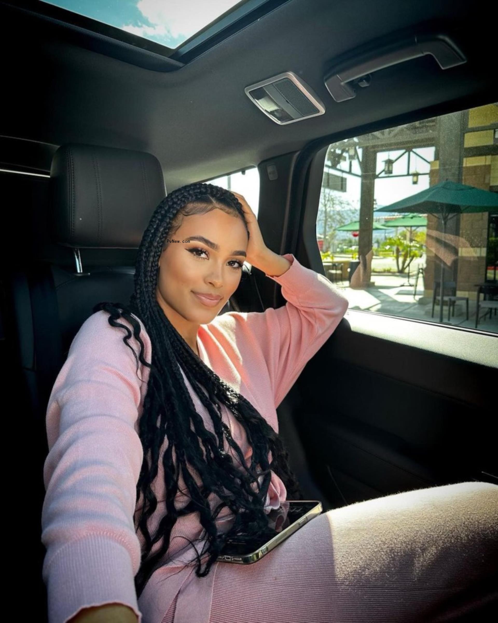 Miya Dickey posing in car smiling.