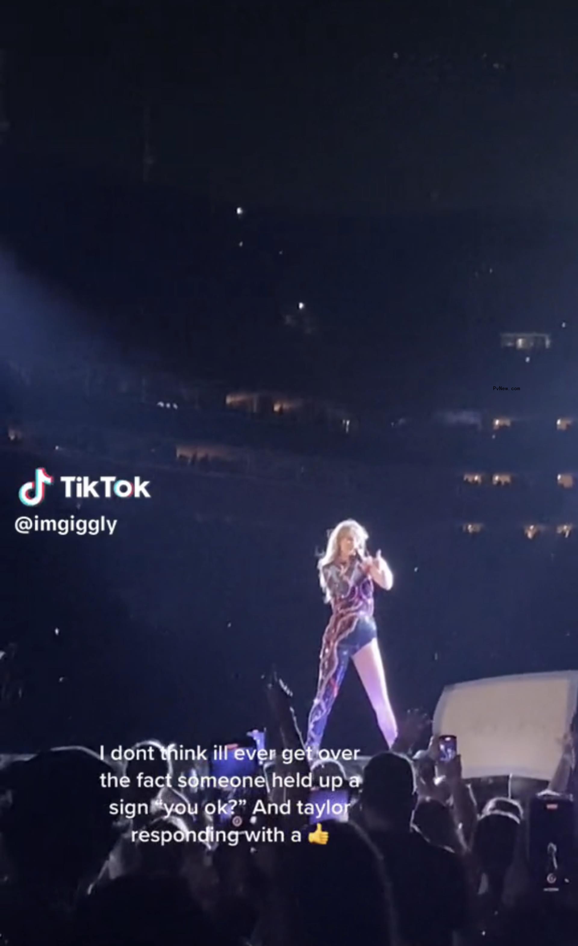 Taylor Swift giving a thumbs-up on stage