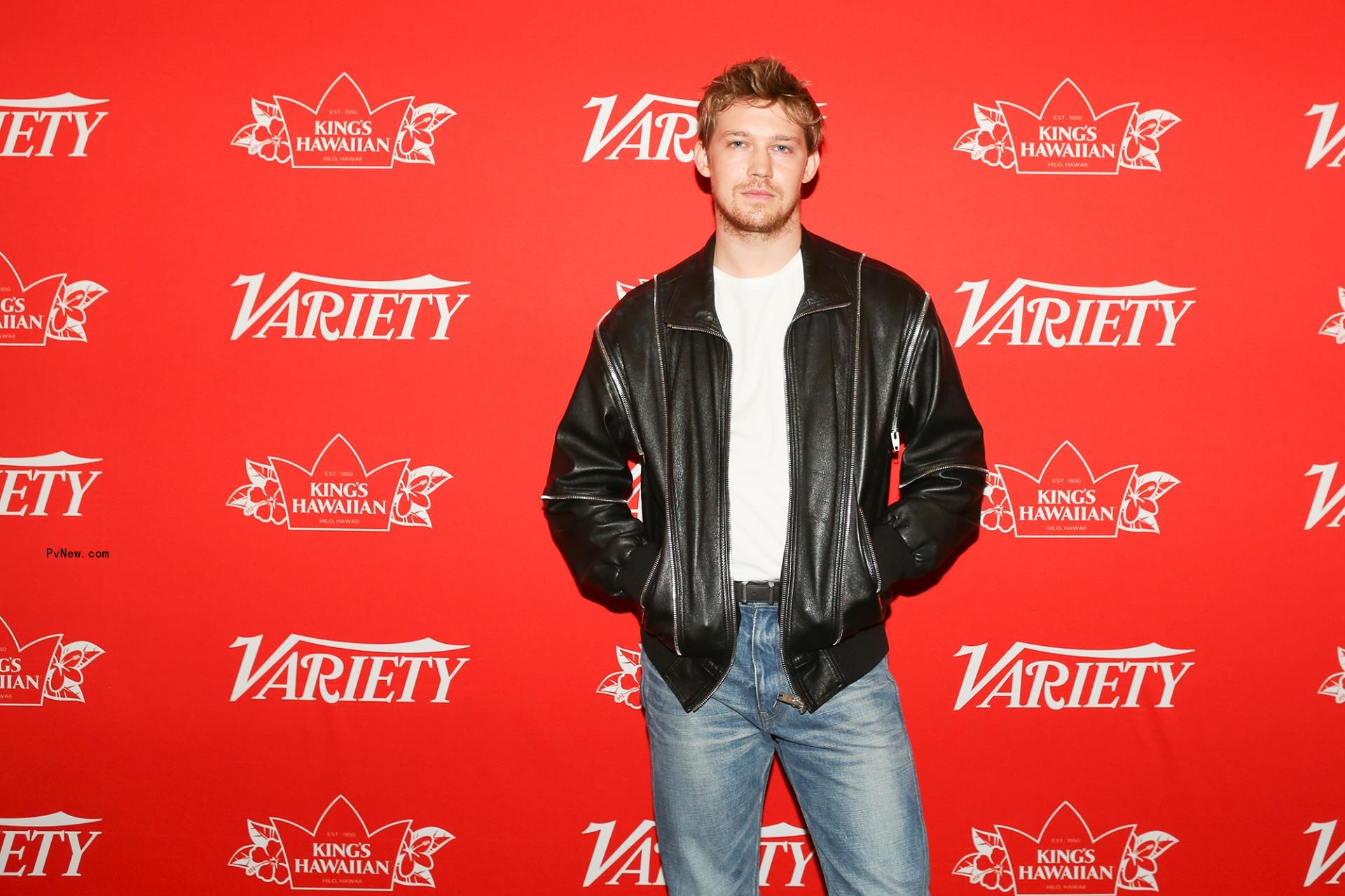 Joe Alwyn posing on a red carpet