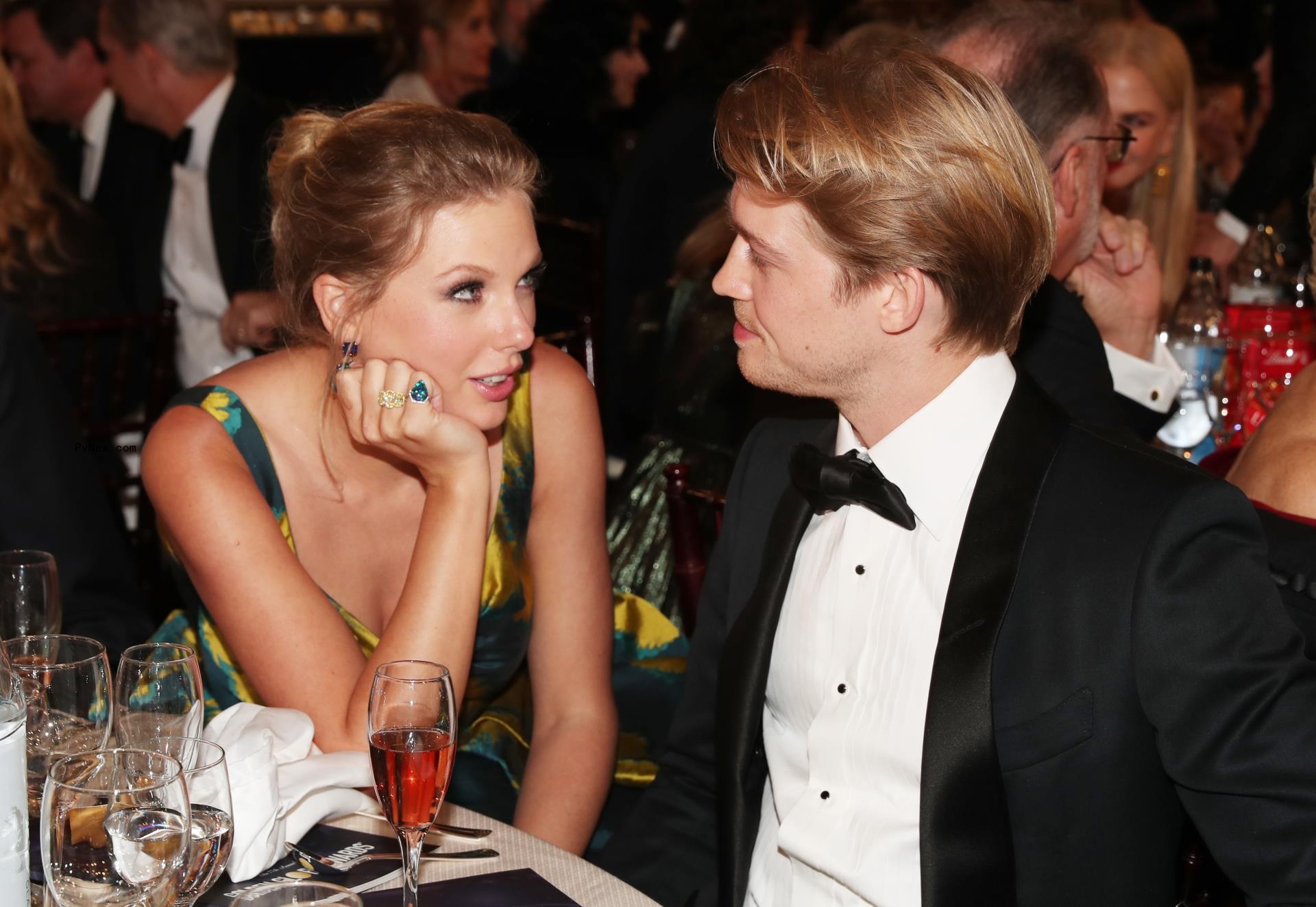 Taylor Swift and Joe Alwyn sitting down at a table together