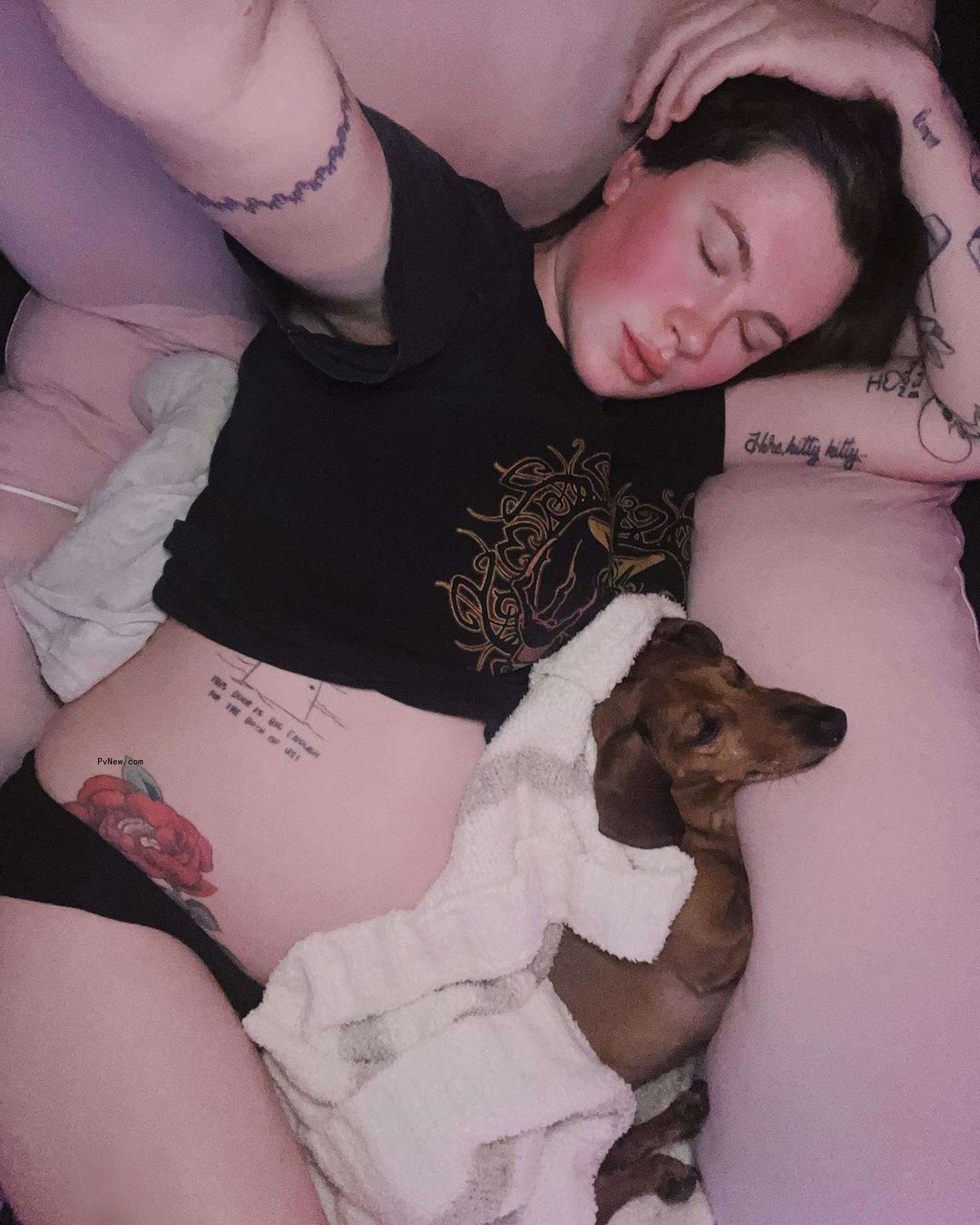Ireland Baldwin rests with dog
