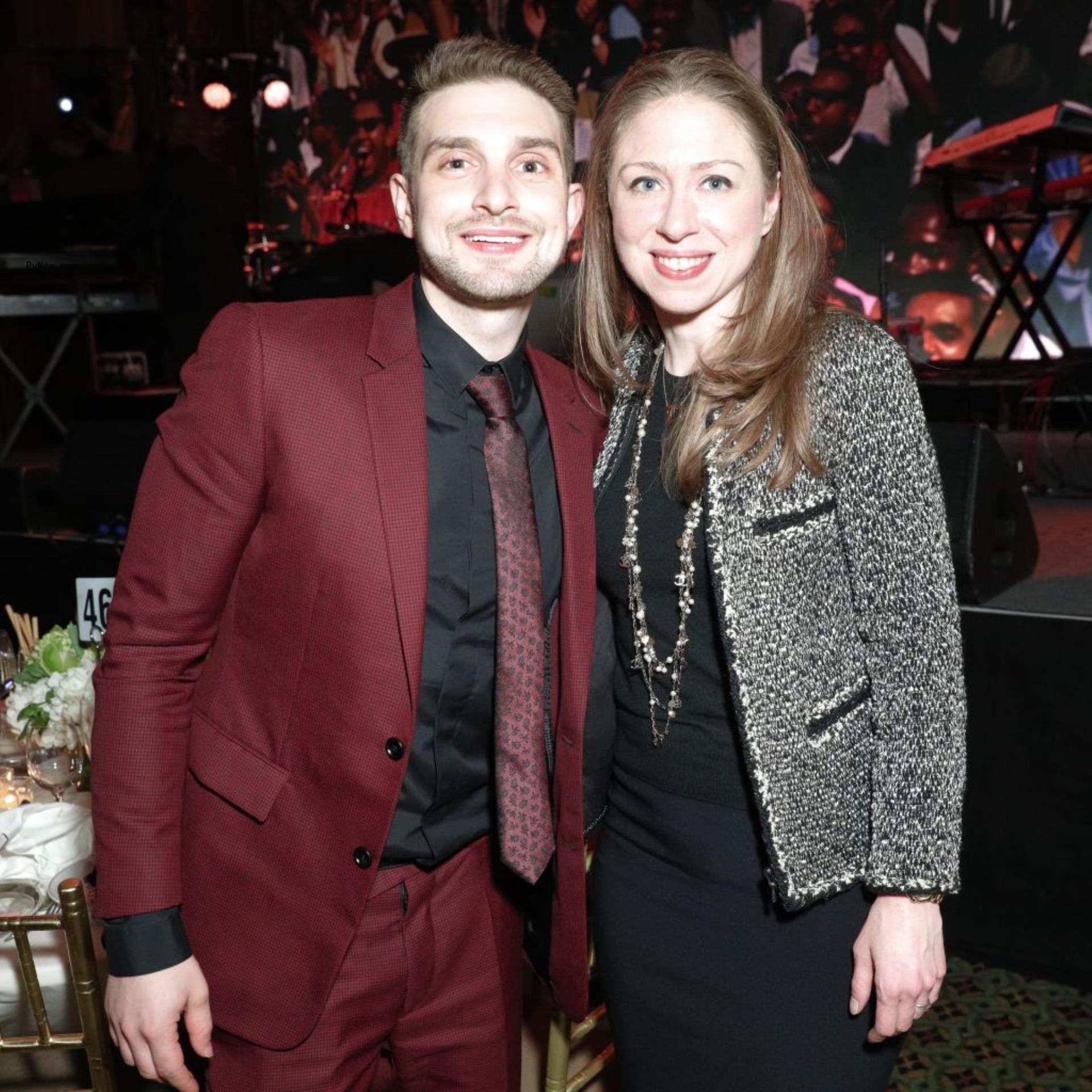 Alex Soros and Chelsea Clinton pose together.