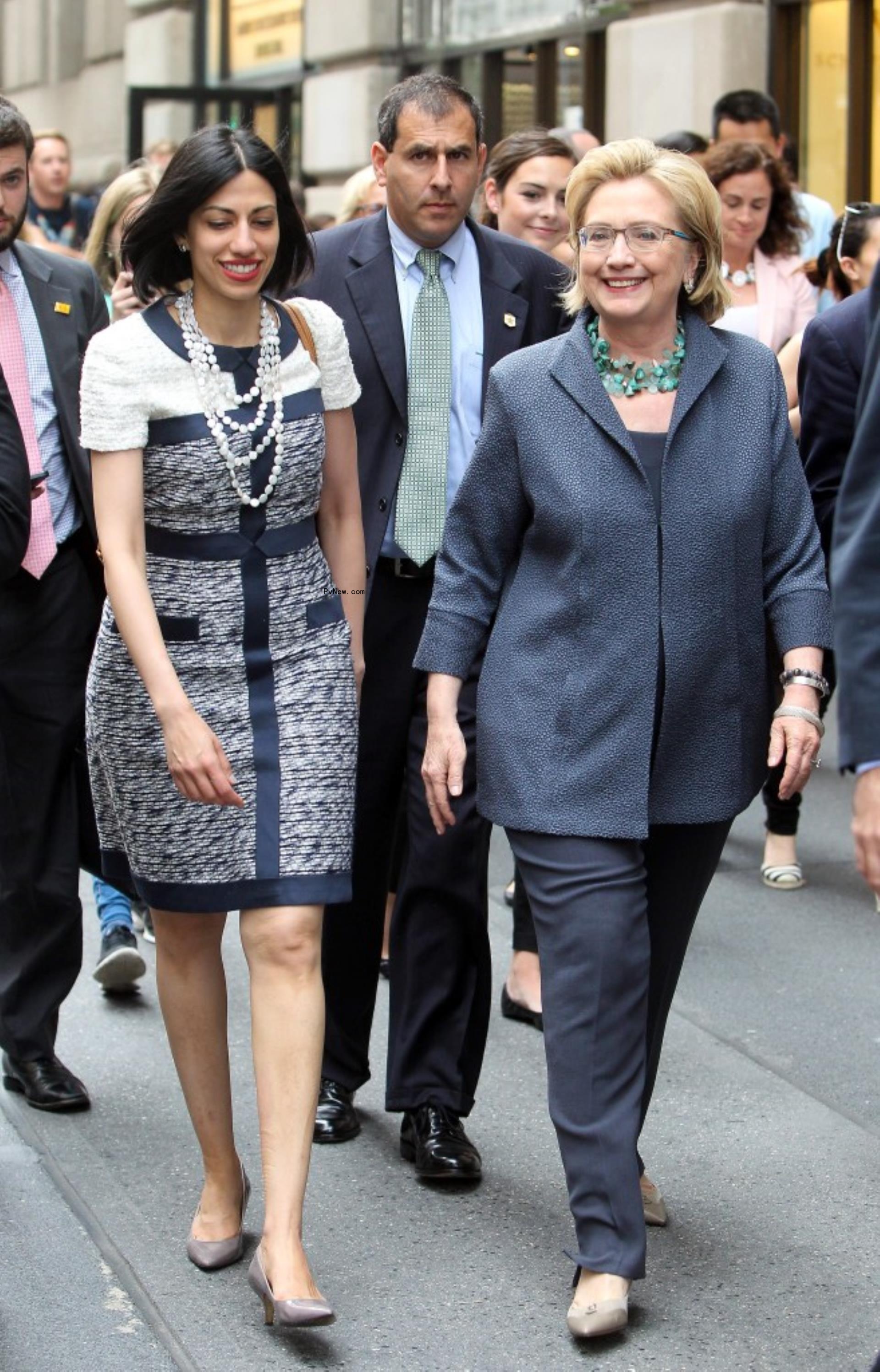Hillary Clinton walks with Huma Abedin.
