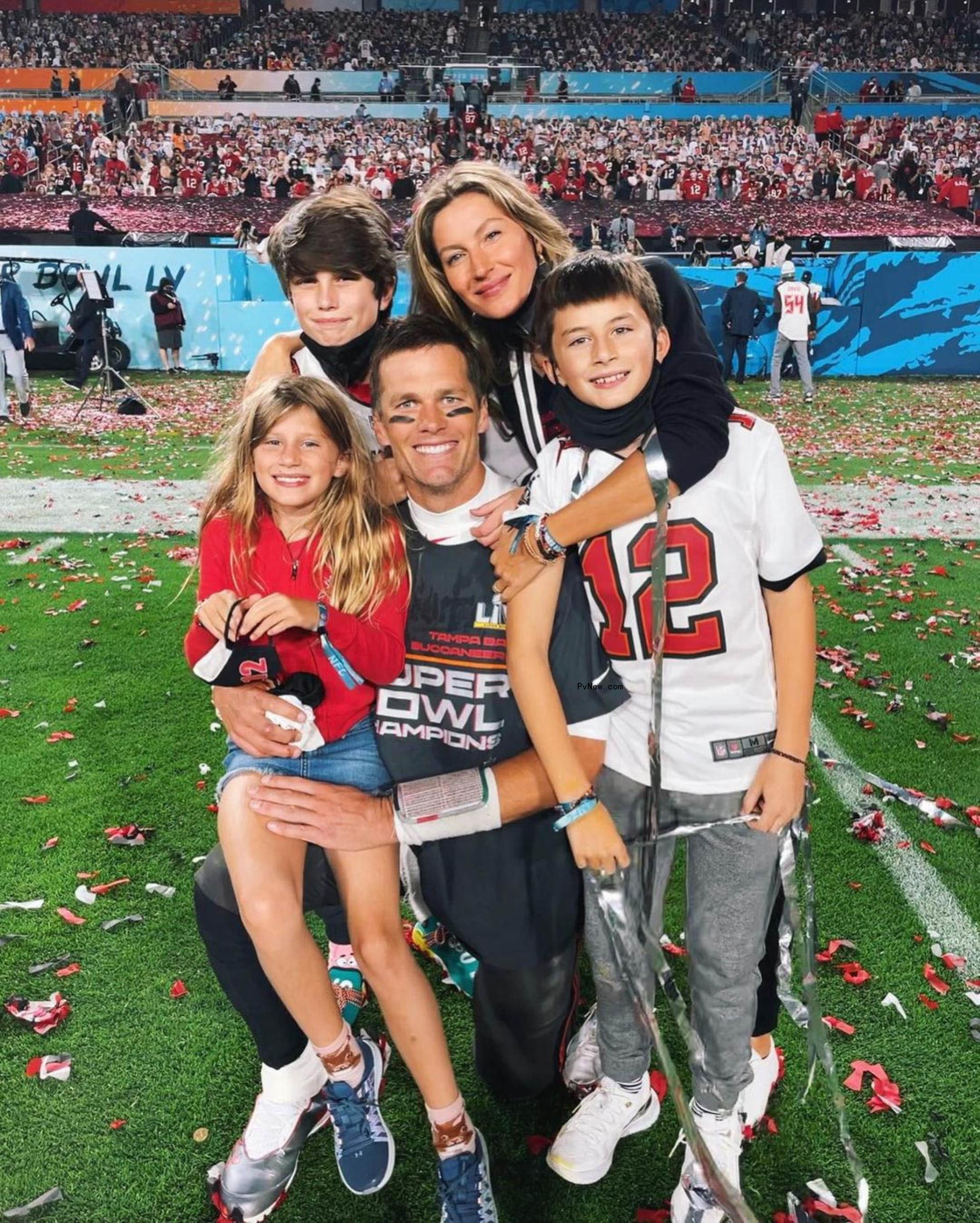 Tom Brady and Gisele Bündchen posing with their kids on the football field