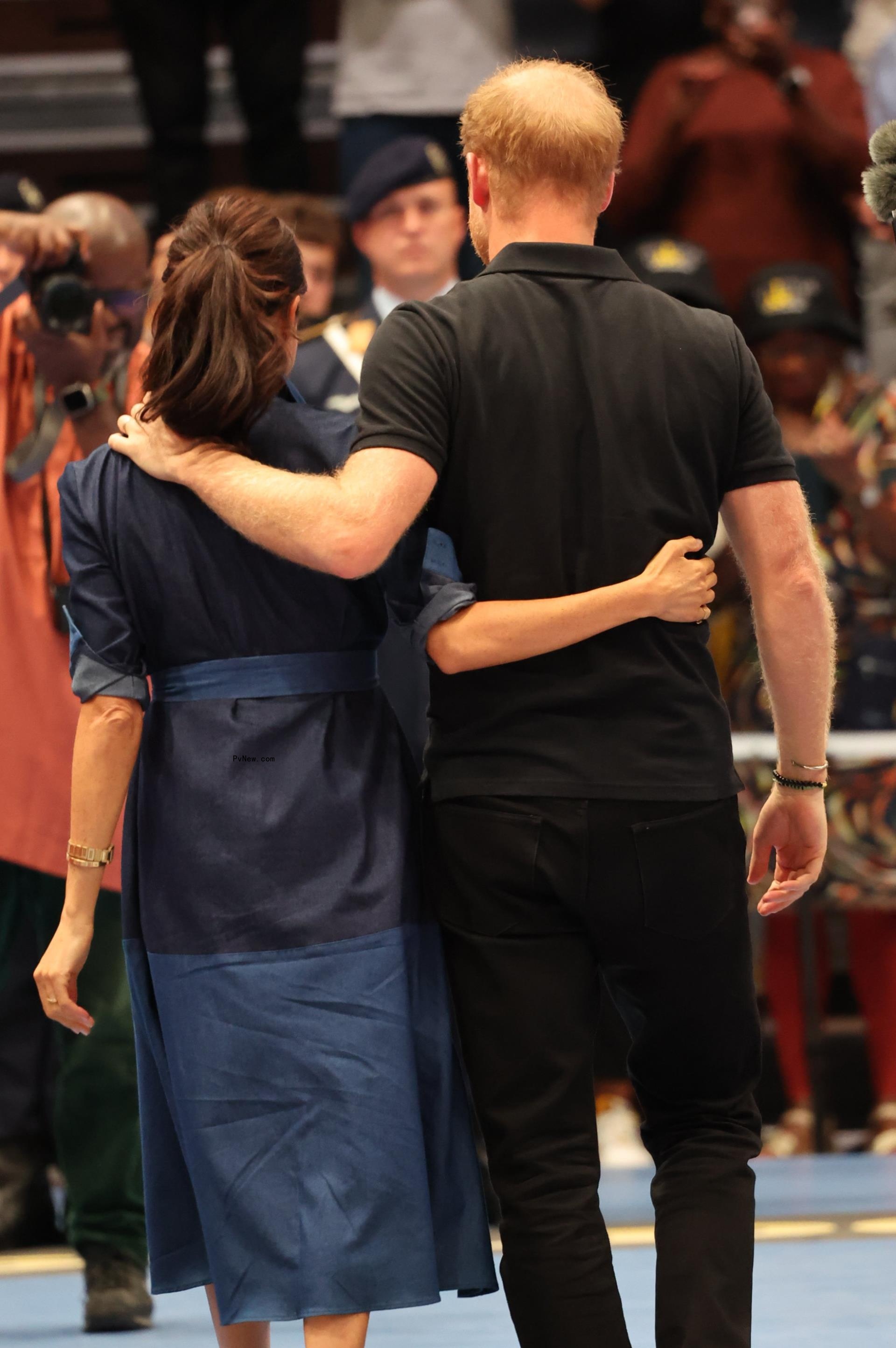 Meghan Markle and Prince Harry holding each other 