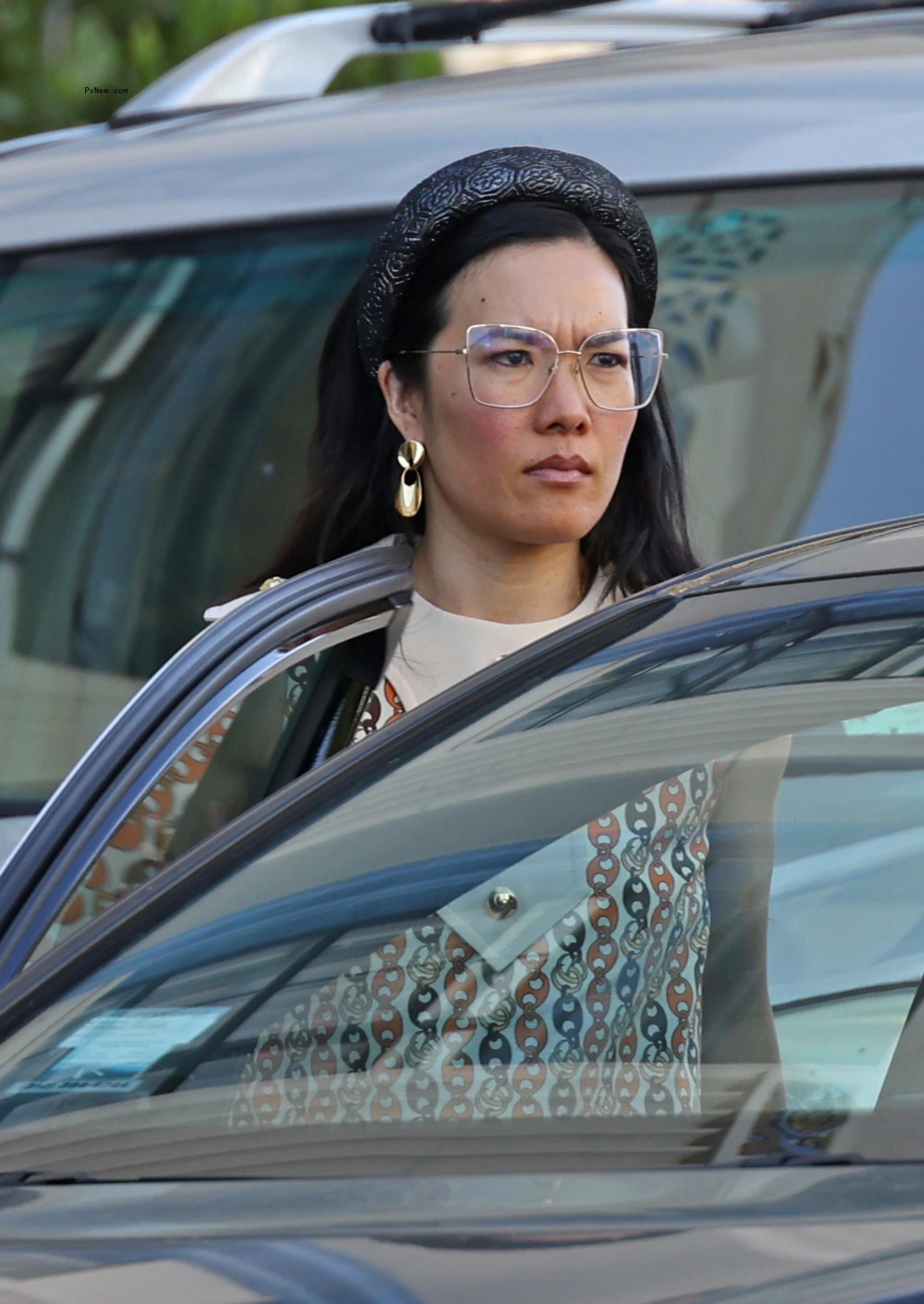 Ali Wong gets into car in dress