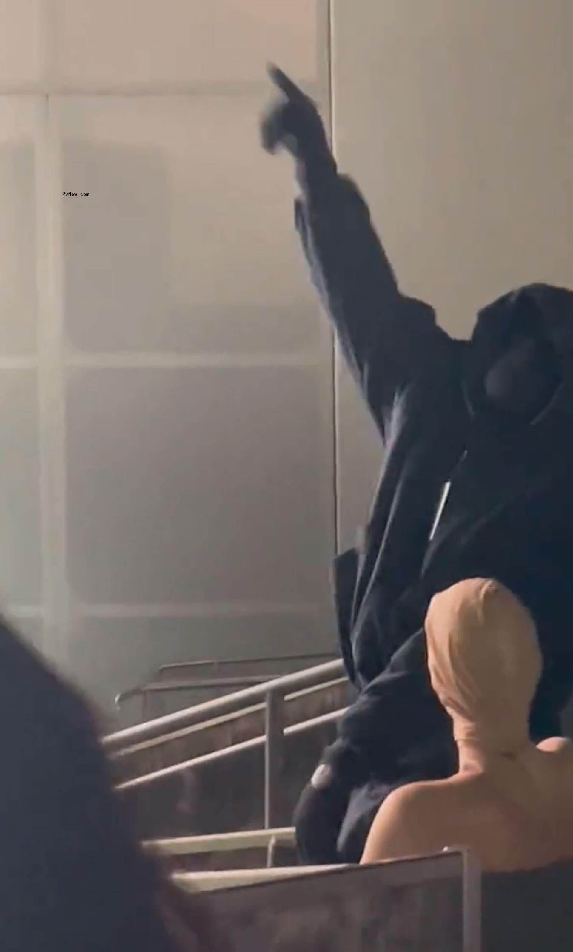 Kanye West pointing next to Bianca Censori