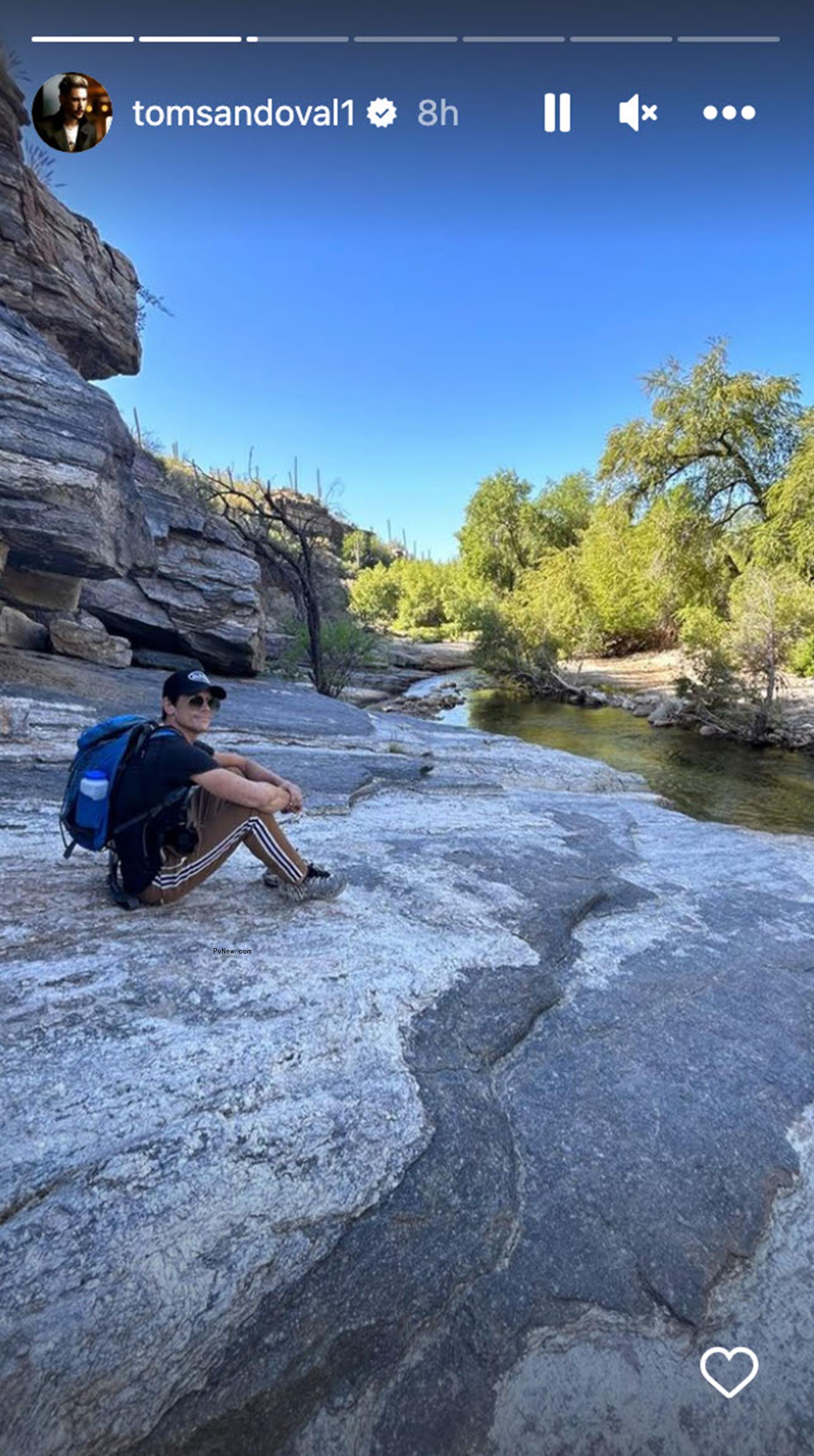 Tom Sandoval sitting by a river