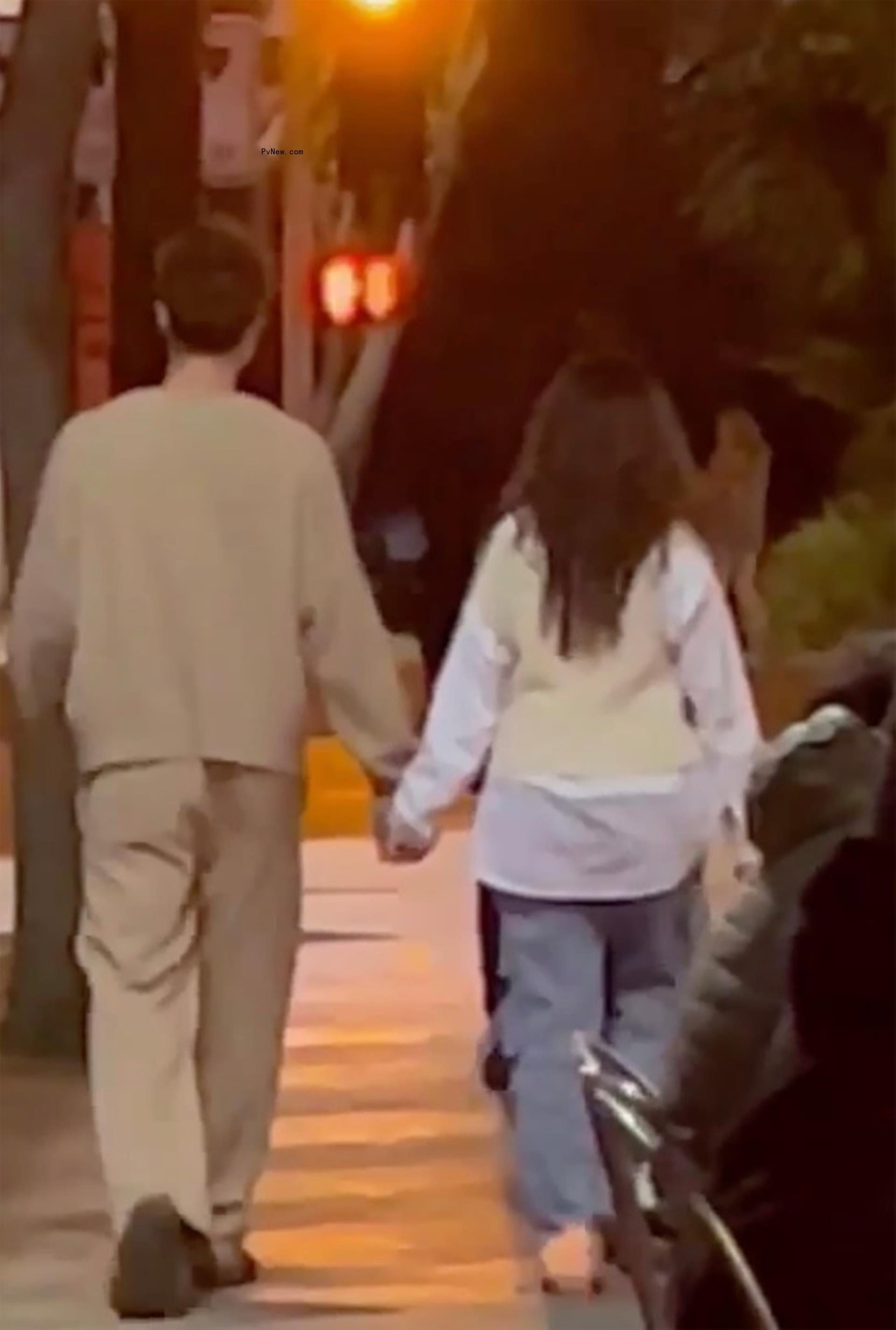 Shawn Mendes and Camila Cabello holding hands while walking together.