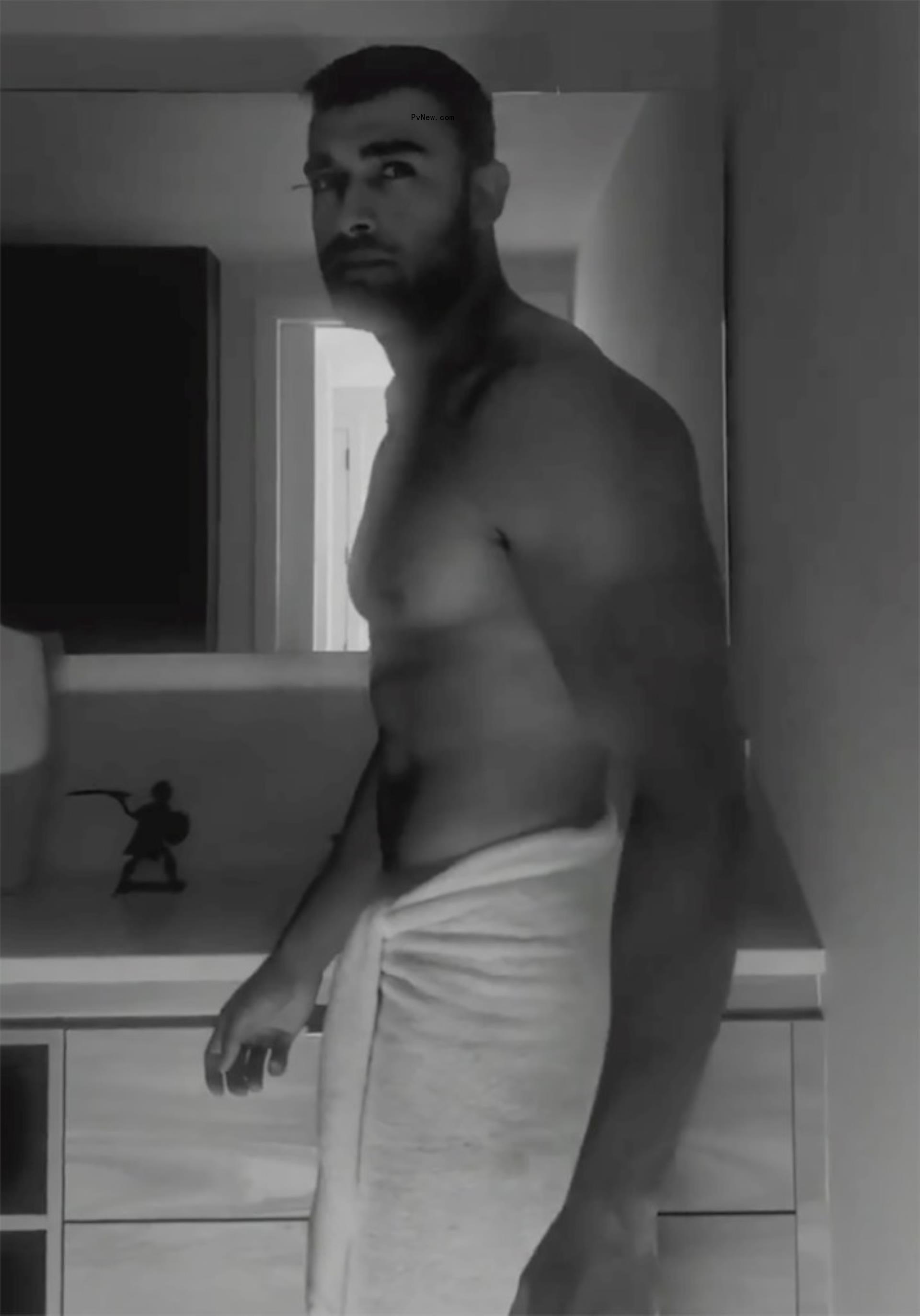 Sam Asghari shirtless with a white towel around his waist