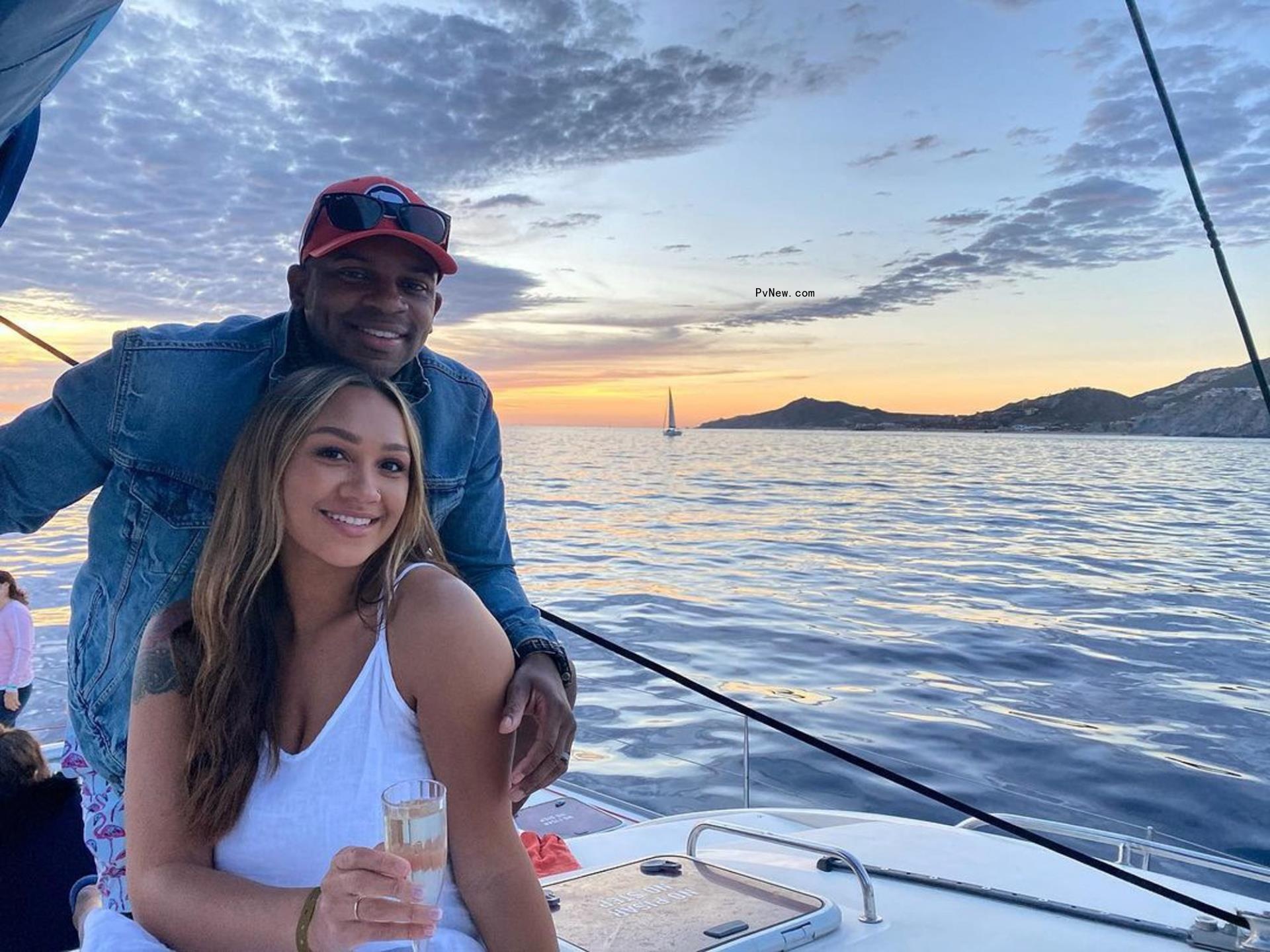 Jimmie Allen and Alexis Gale pose on boat at sunset
