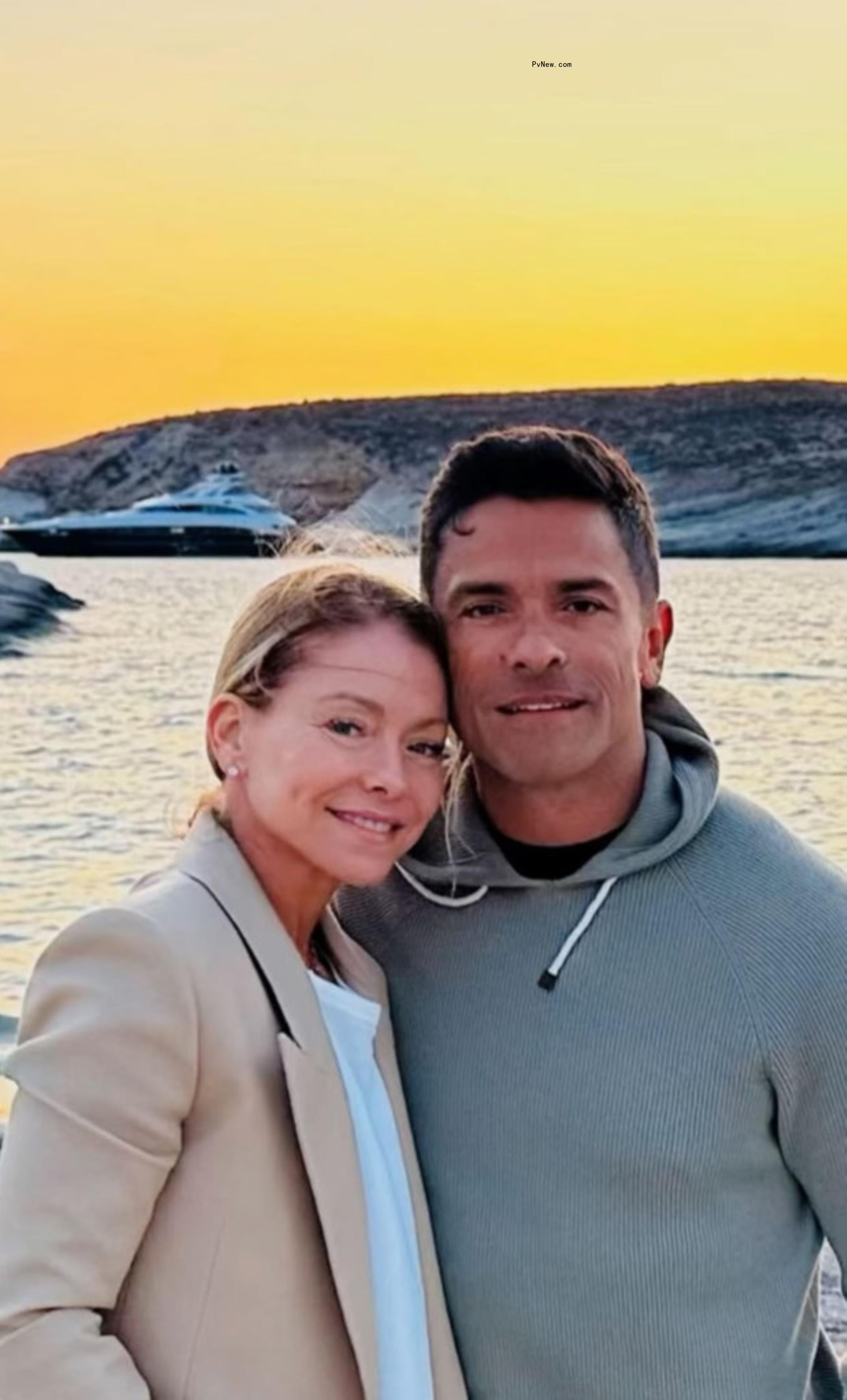 Kelly Ripa and Mark Co<i></i>nsuelos smile in front of the water at sunset.