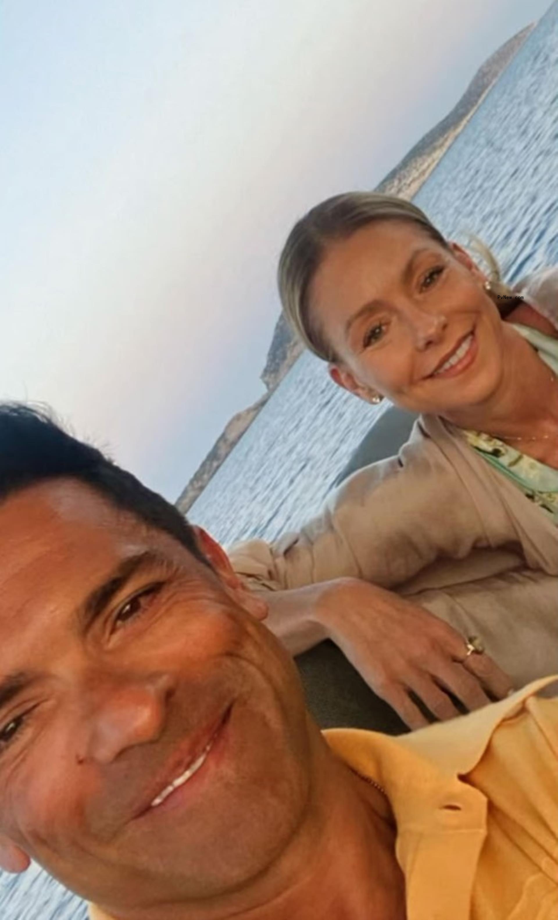Kelly Ripa and Mark Co<i></i>nsuelos smile for a selfie on a boat.
