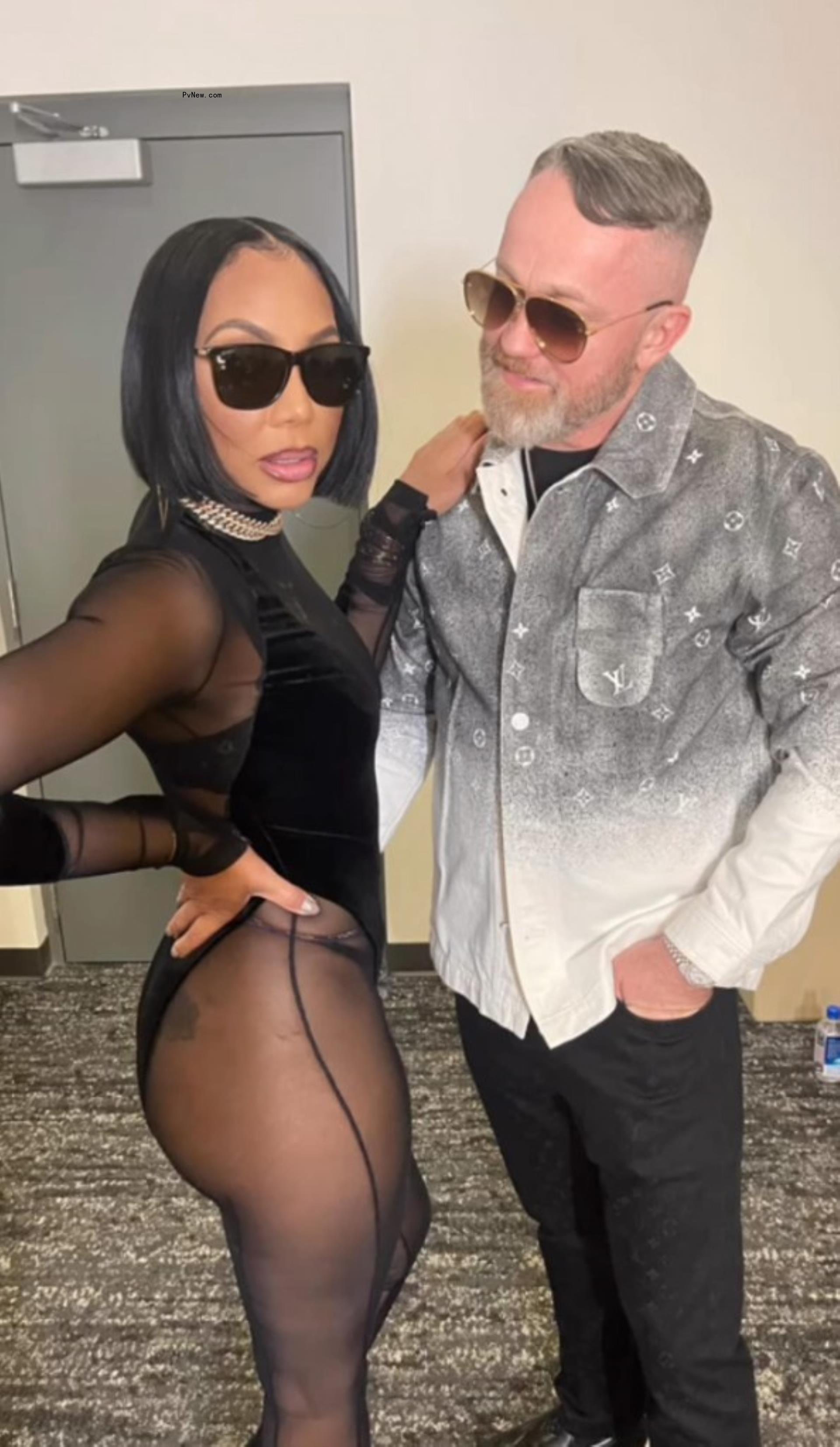 tamar braxton in a leotard posing with fiance jeremy