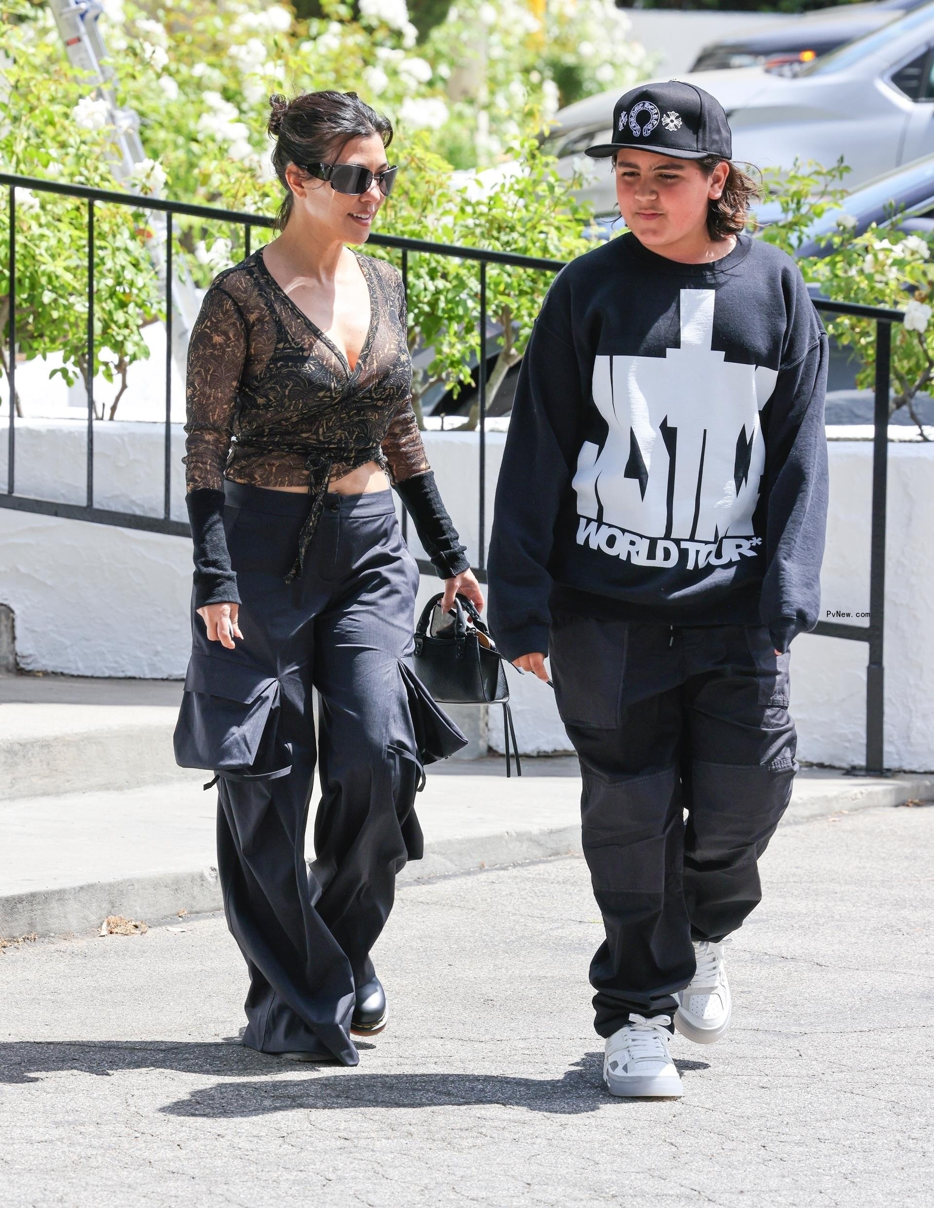 Kourtney Kardashian blowing out candles with Reign Disick