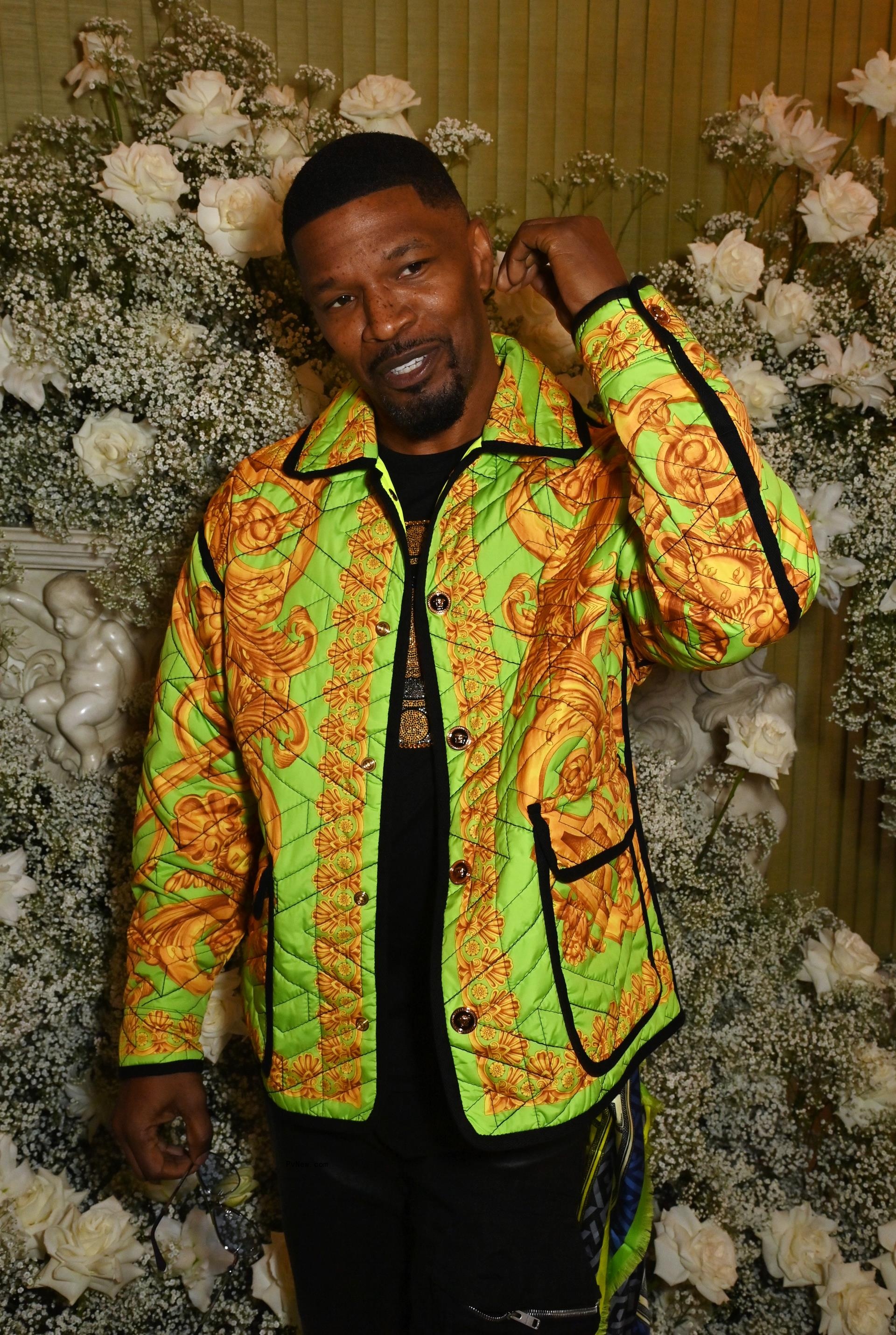 Jamie Foxx poses in colorful jacket