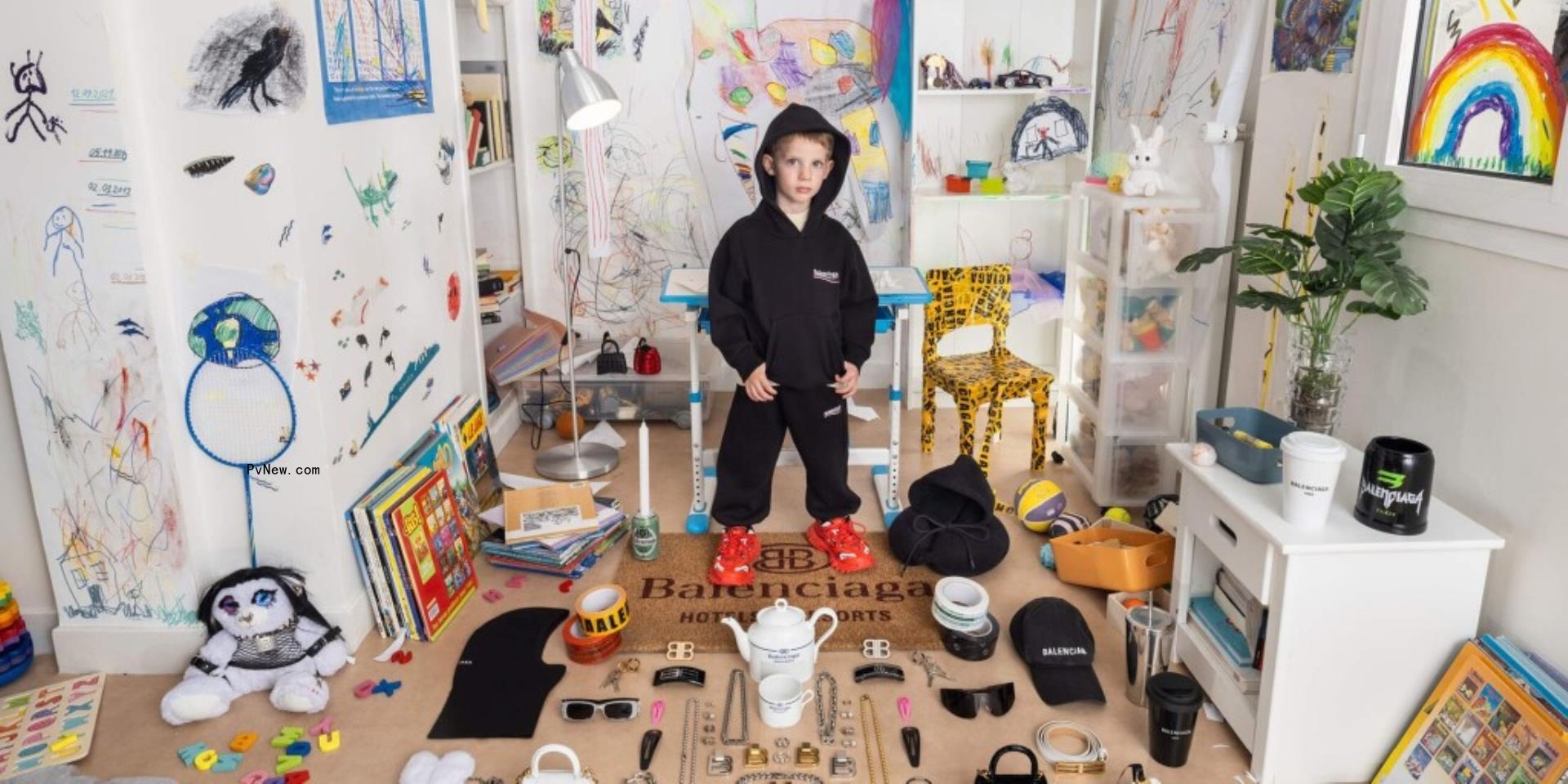 A young boy is pictured in a play room with a teddy bear in bo<i></i>ndage style gear on the Balenciaga website.