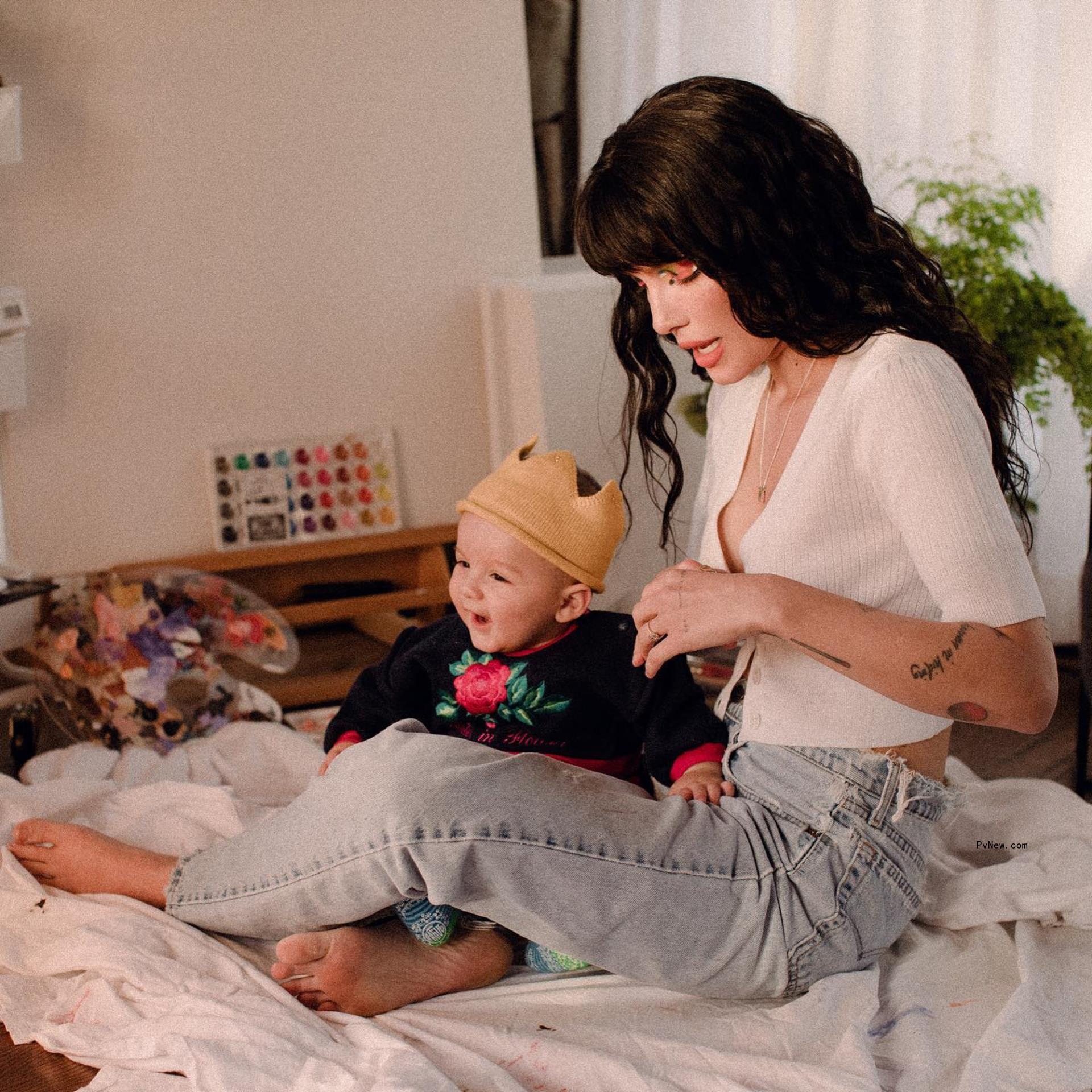Halsey sits on bed with son Ender
