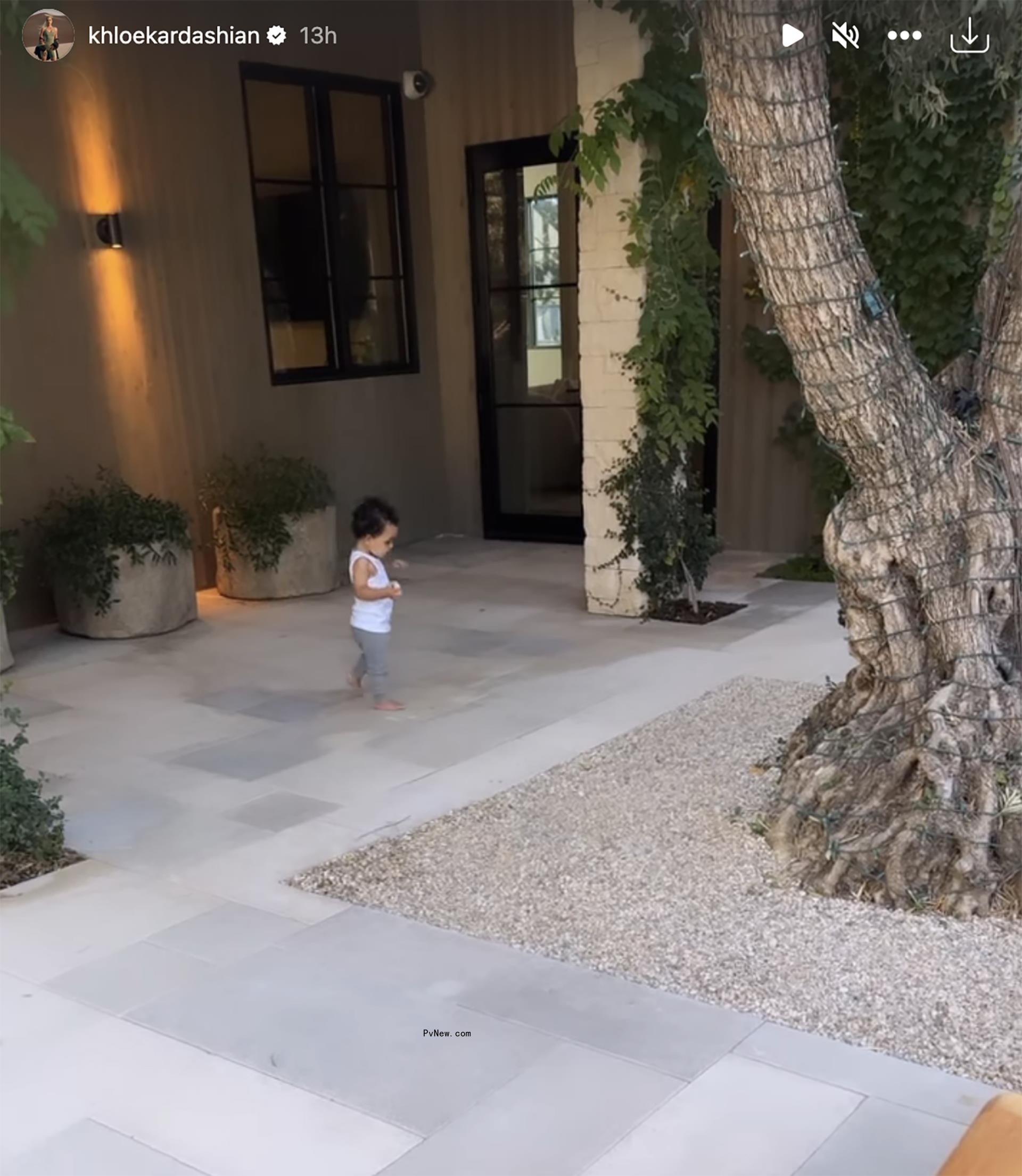 Tatum Thompson walking   while dressed in gray sweats and a white tank top 