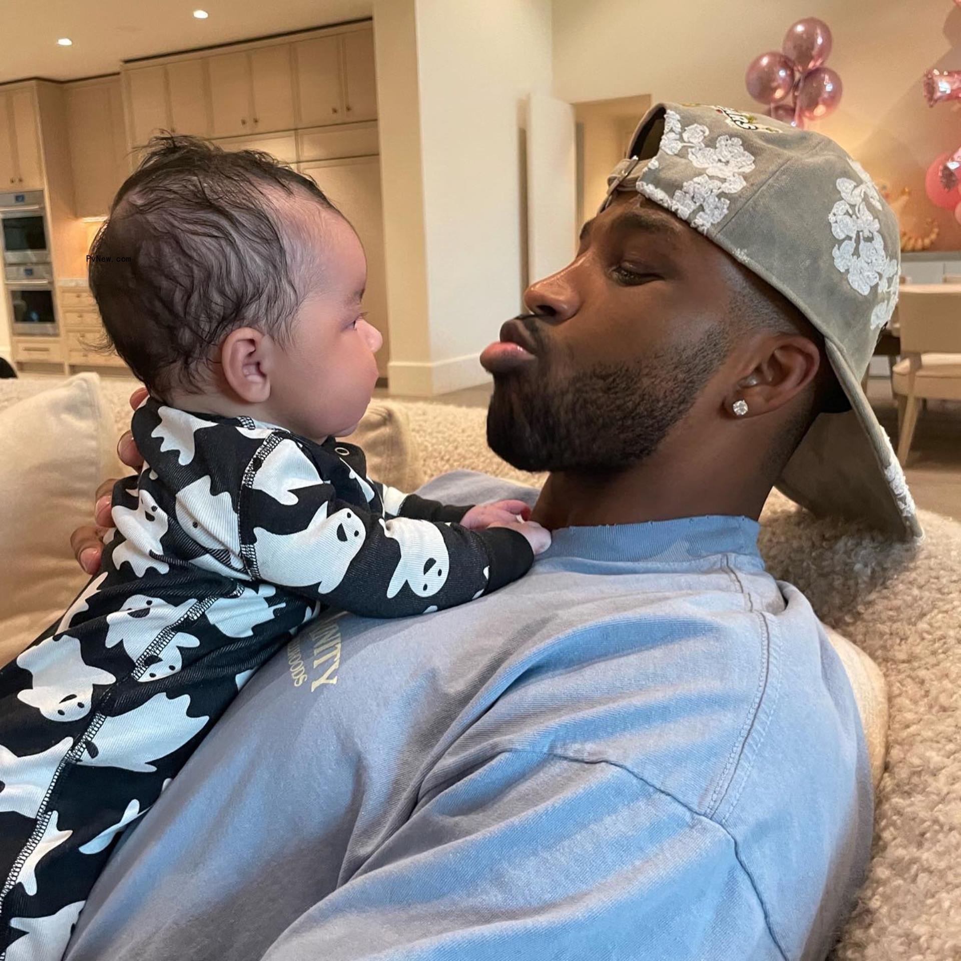 Tristan Thompson with son tatum standing on his lap
